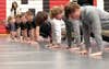 High school military recruits participate in a friendly push-up competition after receiving their oath of enlistment from Lt. Gen. Xavier Brunson, commander of America’s First Corps, at Saint Martin University, Lacey, Wash., May 3, 2022. Recruits were treated to a buffet-style dinner after the oath of enlistment, with family and friends also in attendance. (U.S. Army photo by Spc. Richard Carlisi, I Corps)