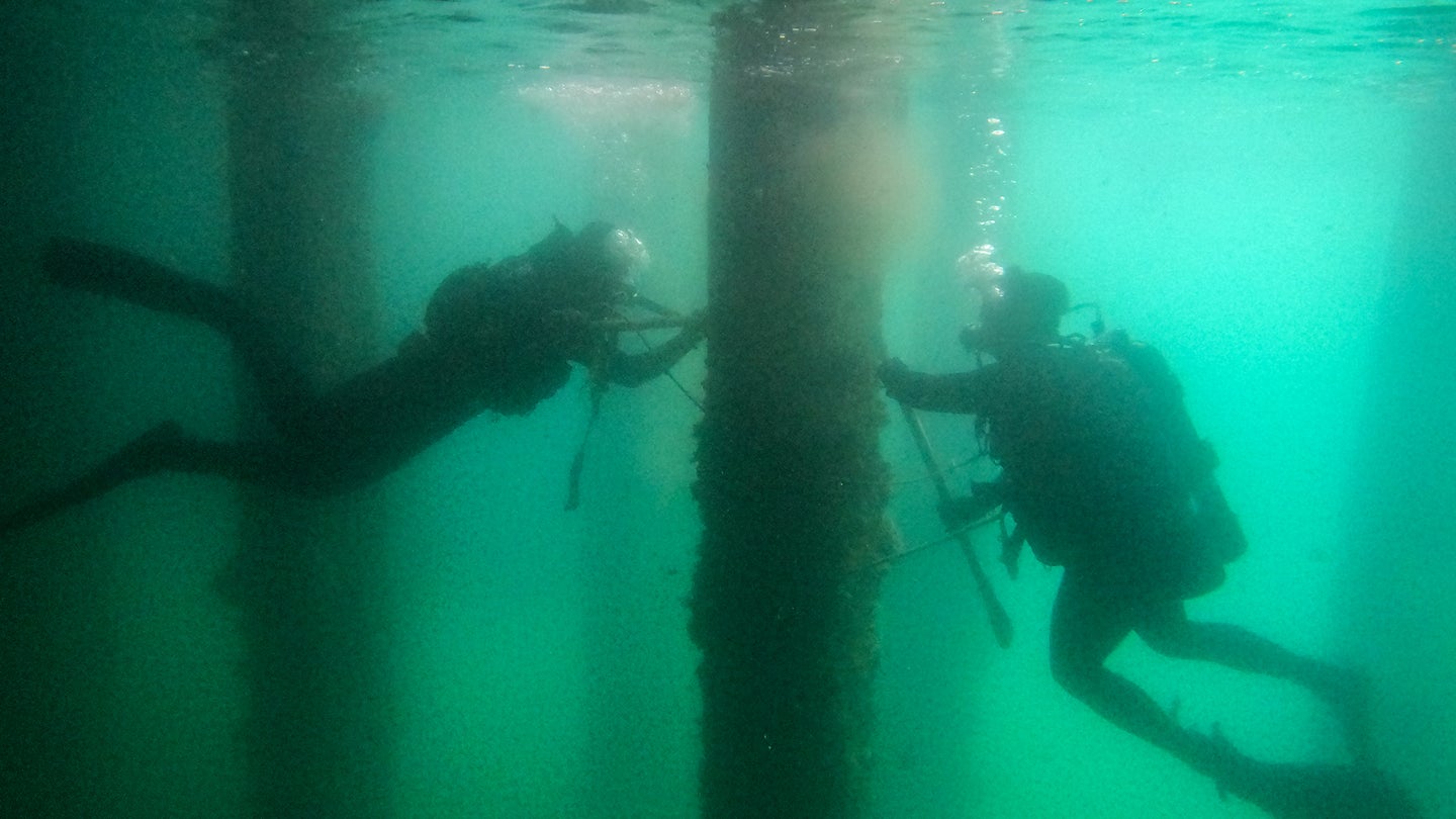 Soldiers from the 7th Engineer Dive Detachment – U.S. Army, 130th Engineer Brigade, conducted a pier survey and assessment to ensure its safety and stability during Rim of the Pacific Exercise (RIMPAC) on Joint Base Pearl Harbor Hickam, Hawaii, July 8, 2022. (Pfc. Owen Stupcenski/U.S. Army)
