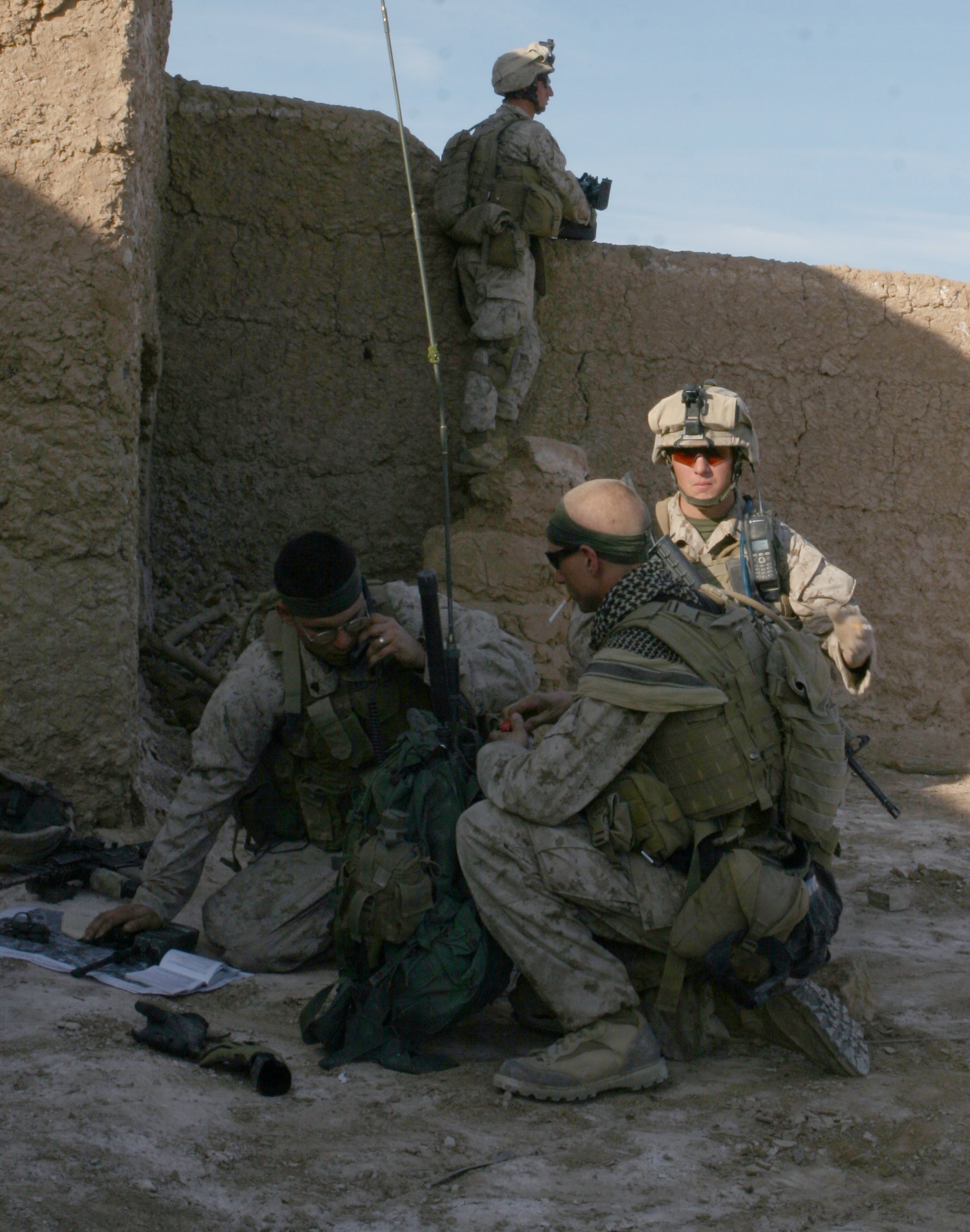 Sgt. Bill Bee, left, on the radio during a firefight in Helmand province, Afghanistan in January 2010. (Cpl. James Clark/U.S. Marine Corps)