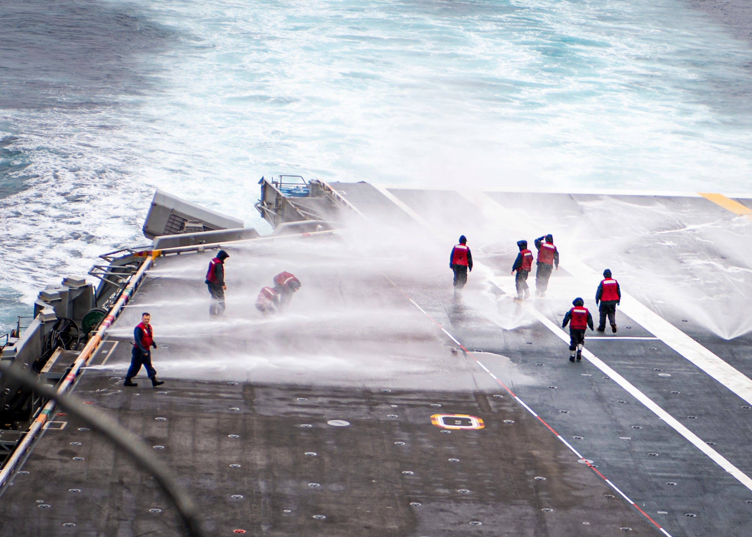 220914-N-XK462-1063 PACIFIC OCEAN (Sep. 14, 2022) Sailors conduct a counter measure washdown on the flight deck of the aircraft carrier USS Nimitz (CVN 68). Nimitz is underway conducting routine operations. (U.S. Navy photo by Mass Communication Specialist 3rd Class Hannah Kantner)