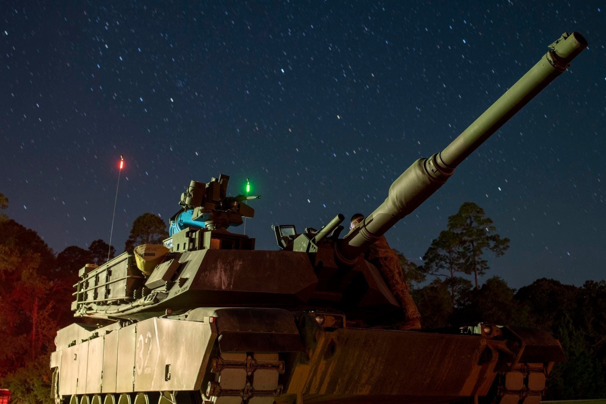 A modernized M1A2 SEPv3 Abrams tank assigned to Bravo Company, 2nd Battalion, 69th Armor Regiment, 2nd Armored Brigade Combat Team, waits in line for night Table VI operator new equipment training at Fort Stewart, Georgia, Sept. 24, 2022. The "Spartan Brigade," 2nd ABCT, 3rd ID, is the Army’s first brigade to complete modernization in accordance with the Army’s new Regionally Aligned Readiness and Modernization Model, or ReARMM, and is on glide path to execute a rotation at the National Training Center at Fort Irwin, California, to validate its readiness and proficiency to deploy, fight and win wherever and whenever the nation calls. (U.S. Army photo by 1st Lt. Jacob Swinson, Executive Officer for Bravo Company, 2nd Bn., 69th AR, 2nd ABCT)