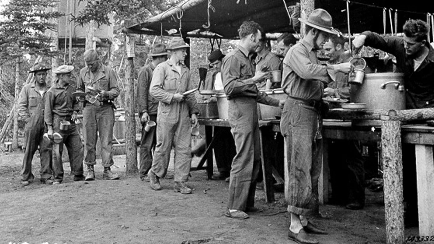 Engineer soldiers in a "chow line" during construction of the Alaskan-Canadian Highway, Aug. 21, 1942. (U.S. Army Quartermaster Museum)