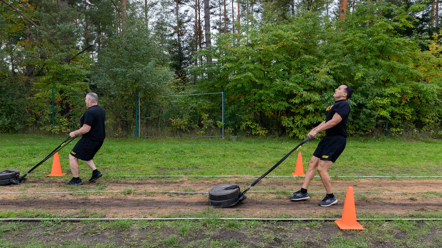 Lt. Col. William Snyder, an engineer officer, and Maj. John Harrison, a field artillery officer, both assigned to Task Force Orion, 27th Infantry Brigade Combat Team, New York Army National Guard, complete the drag portion of the sprint-drag-carry event during the Army Combat Fitness Test at Grafenwoehr, Germany, Sept. 29, 2022.   (Staff Sgt. Jordan Sivayavirojna/ U.S. Army National Guard)