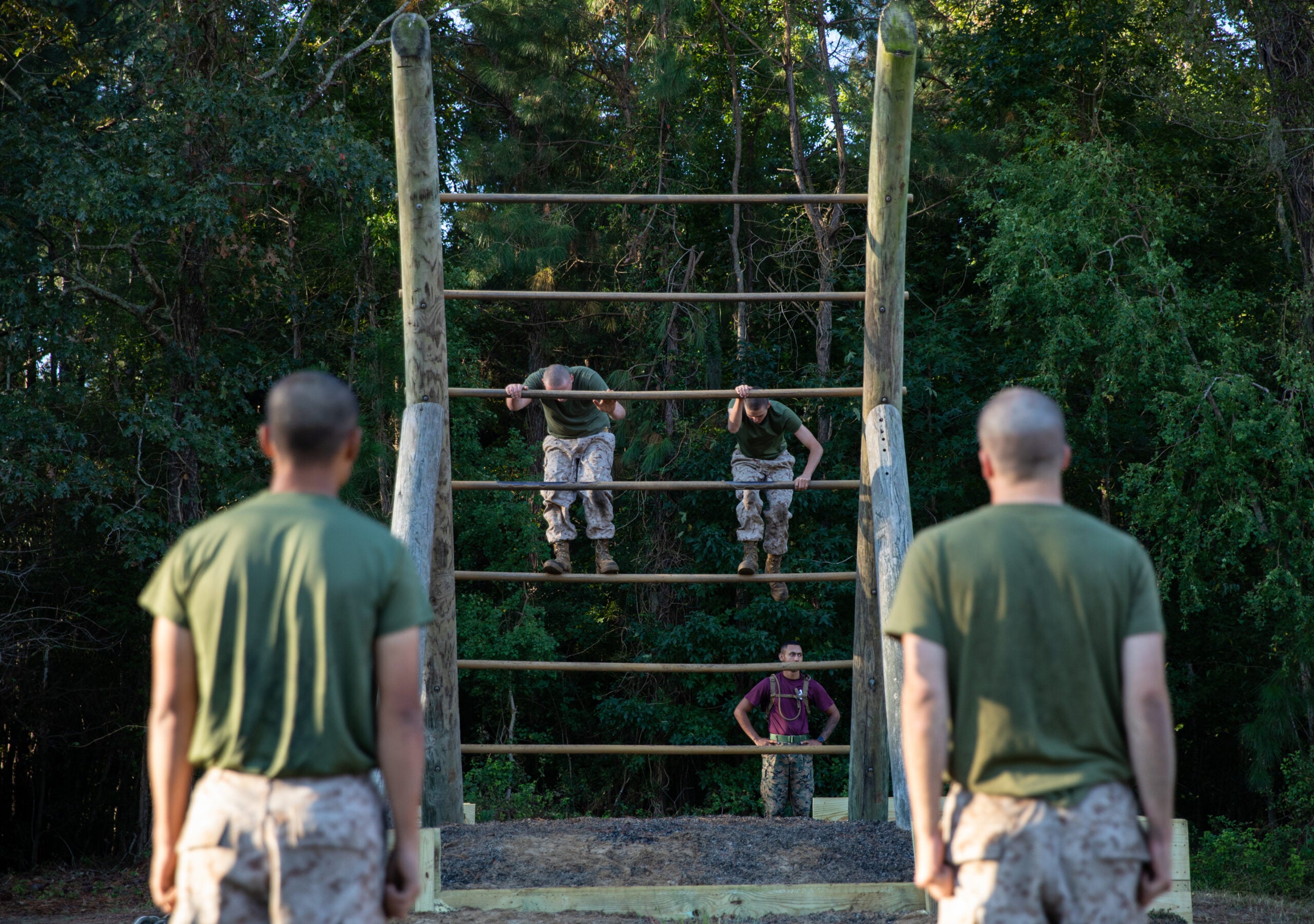 Recruits with Oscar Company, 4th Recruit Training Battalion, execute obstacles on the Confidence Course aboard Marine Corps Recruit Depot Parris Island, S.C. October 20, 2022. The Confidence Course tests the recruits abilities of performing upper body strength and overcoming fear. (U.S. Marine Corps photo by Lance Cpl. Loriann Dauscher)