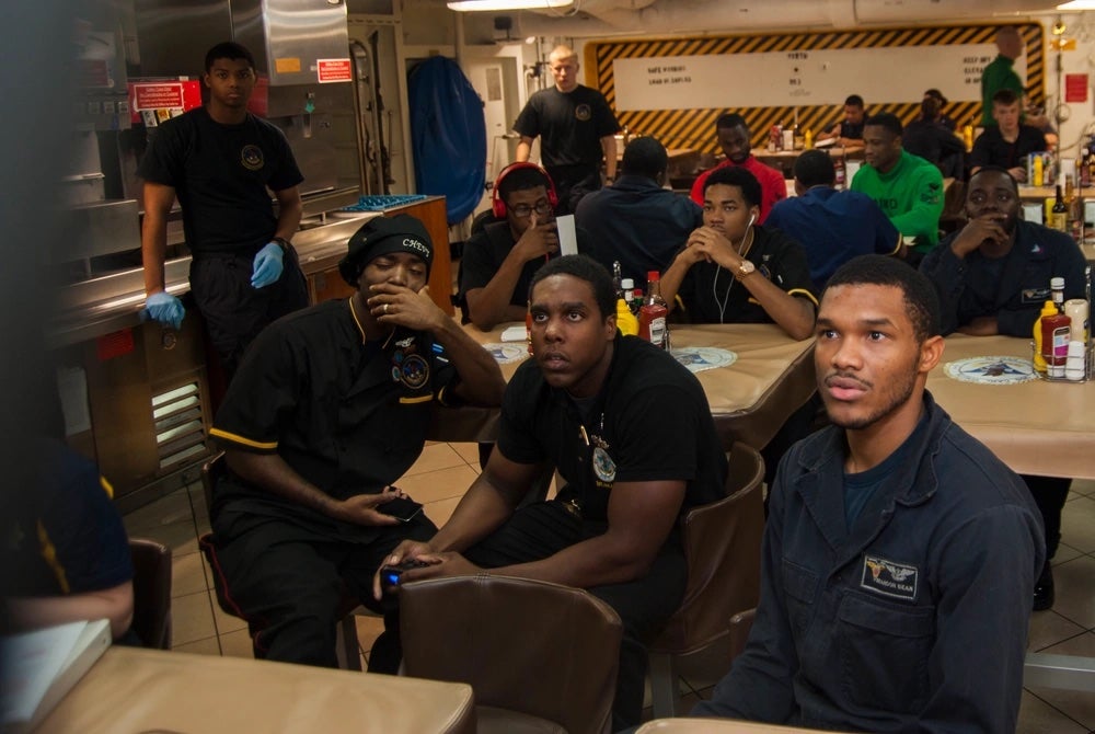 Fire Controlman 2nd Class Louis Perry and Airman Brandon Bean compete in an NBA 2K15 video game tournament hosted by Morale Welfare and Recreation (MWR) on the Nimitz-class aircraft carrier USS Carl Vinson (CVN 70), November 5, 2014. (Mass Communication Specialist 3rd Class Kristopher S. Haley/U.S. Navy)