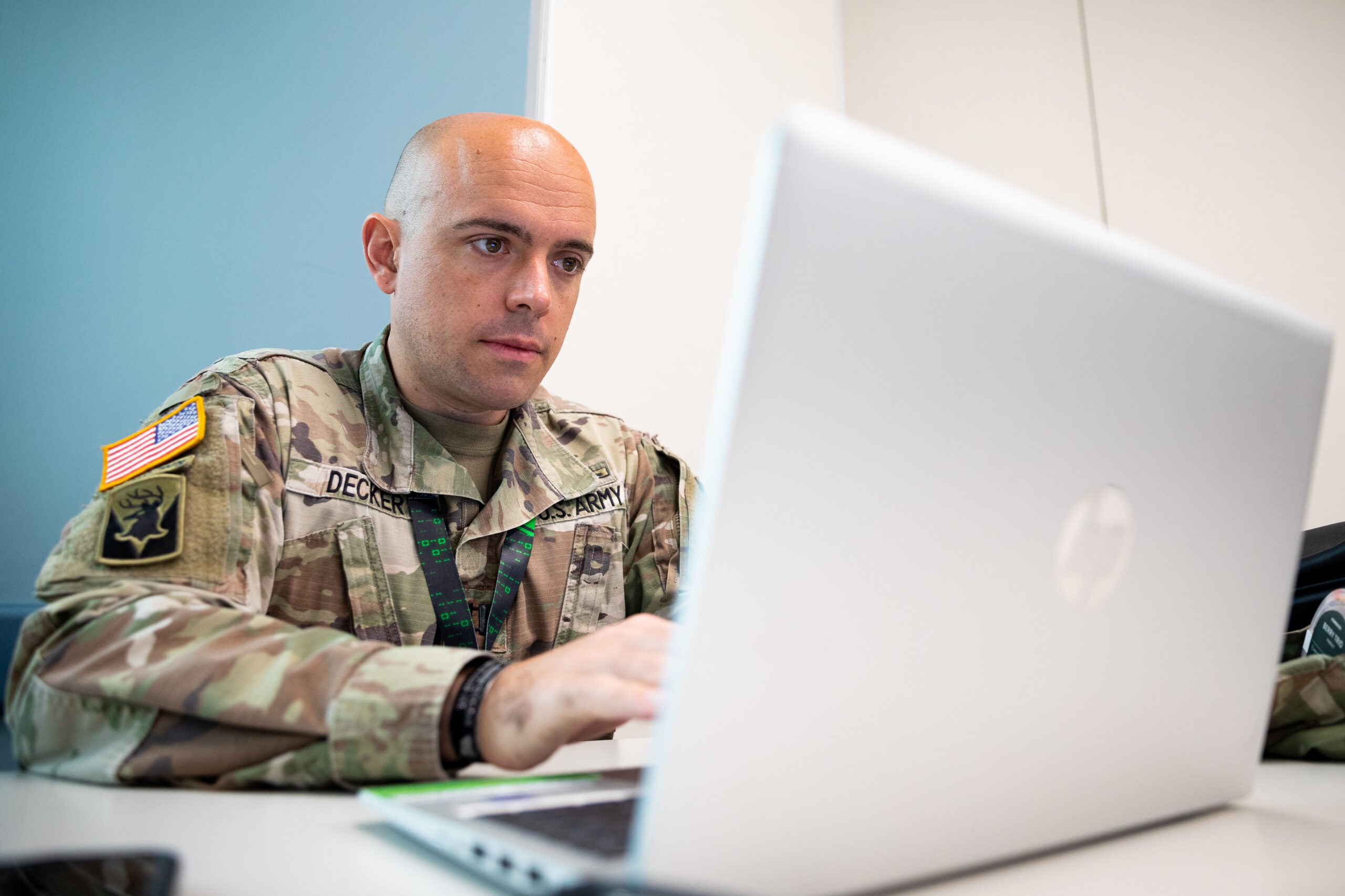 U.S. Army Capt. Vergil Decker, an Army Judge Advocate General's (JAG) Corps attorney assigned to the New Hampshire Army National Guard, works on a laptop at Camp Nett, Niantic, Connecticut, June 16, 2022. Personnel from the JAG played a key role in Cyber Yankee, a cyber training exercise, advising on cyber law issues. (U.S. Army photo by Sgt. Matthew Lucibello)