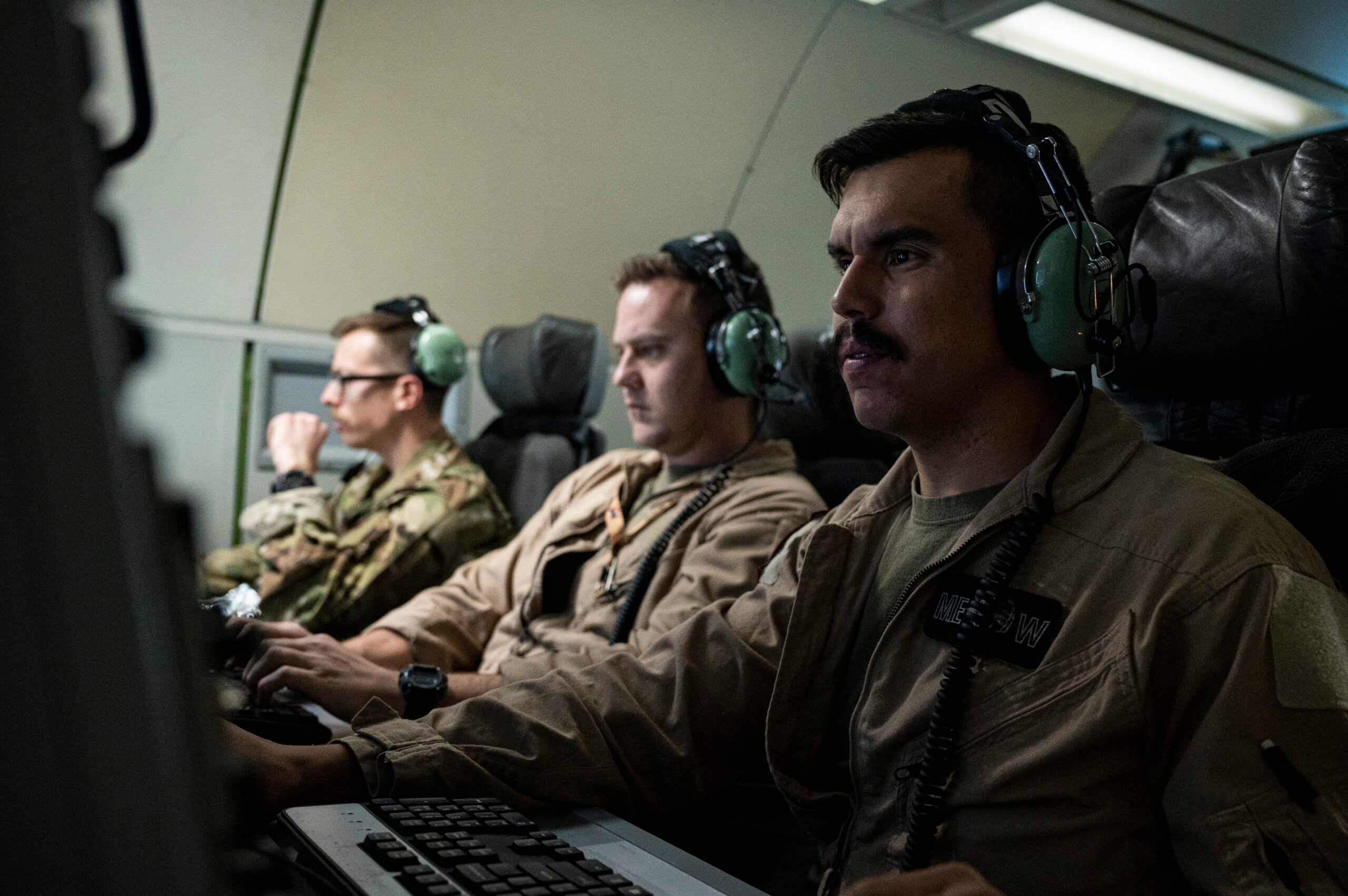 U.S. Air Force Airman 1st Class Jose Resto Abreu, 968th Expeditionary Airborne Air Control Squadron mission systems operator, checks his computer during Exercise Yellow Sands, July 27, 2022. Exercise Yellow Sands tests aircrew skills in detecting and countering unmanned aerial systems. The 968th EAACS's E-3 Sentry delivers real-time tactical decision-making and battlefield awareness to U.S. and partner nation assets. (U.S. Air Force photo by Staff Sgt. Christian Sullivan)