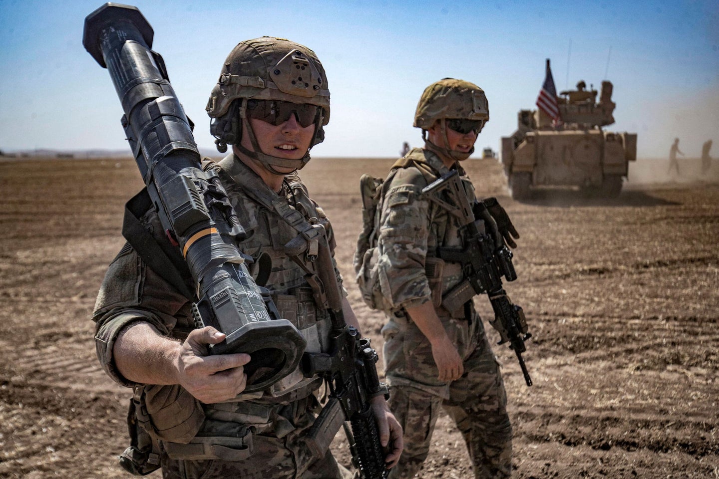 A US soldier walks with an AT4 anti-tank weapon during a joint military exercise between forces of the US-led "Combined Joint Task Force-Operation Inherent Resolve" coalition against the Islamic State (IS) group and members of the Syrian Democratic Forces (SDF) in the countryside of the town of al-Malikiya (Derik in Kurdish) in Syria's northeastern Hasakah province on September 7, 2022. (Photo by Delil SOULEIMAN / AFP) (Photo by DELIL SOULEIMAN/AFP via Getty Images)