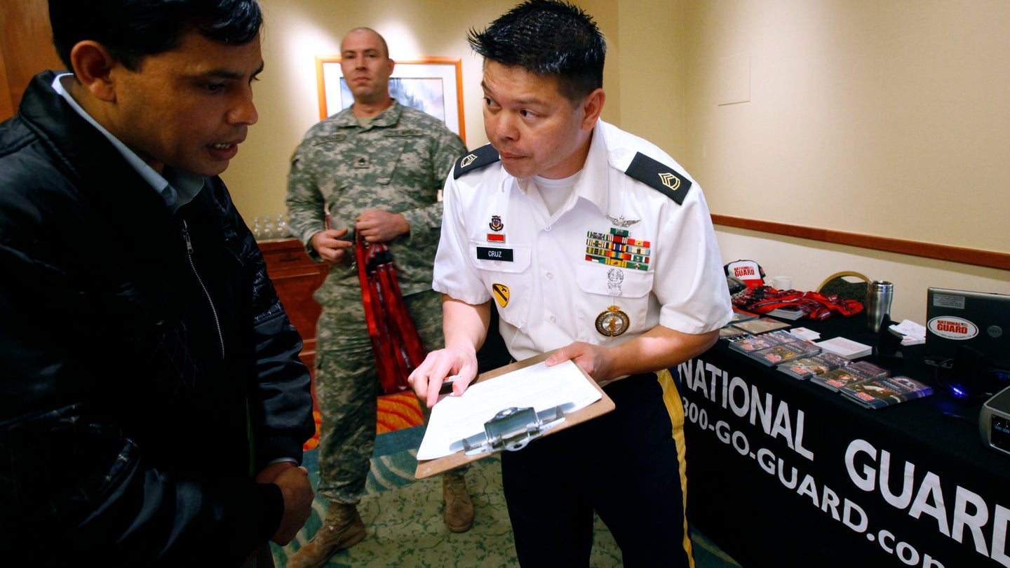 In this March 1, 2011 photo, Army National Guard Sgt. 1st Class Duane Cruz, right, recruits Krishna Biswa, of Tukwila, Wash., at a job fair as Staff Sgt. Rick Strickland looks on, in SeaTac, Wash. (Elaine Thompson/AP Photo)
