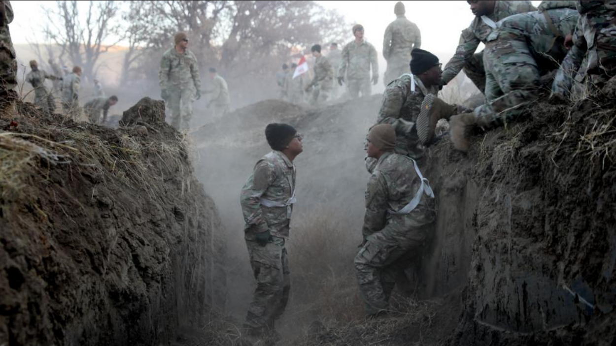 Soldiers in the 4th Infantry Division climb through trenches as part of an obstacle course on Nov. 23, 2022. (Photo by SSG Ondirae H. Abdullah-Robinson/U.S. Army) 
