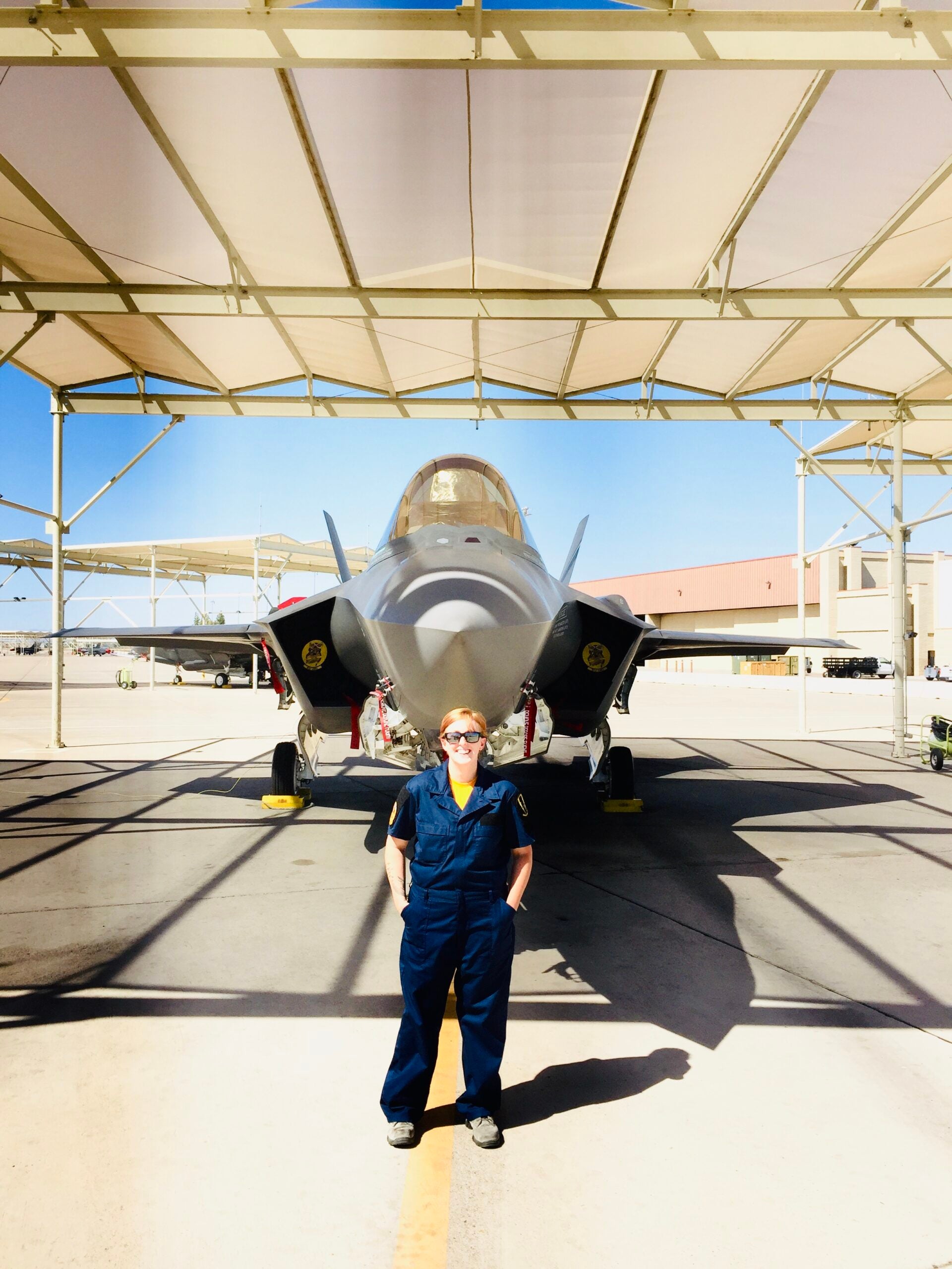 Air Force F-35 maintainer Leah Curtin poses with an F-35 at Luke Air Force Base, Arizona in 2016. (Photo Courtesy Master Sgt. Leah Curtin)