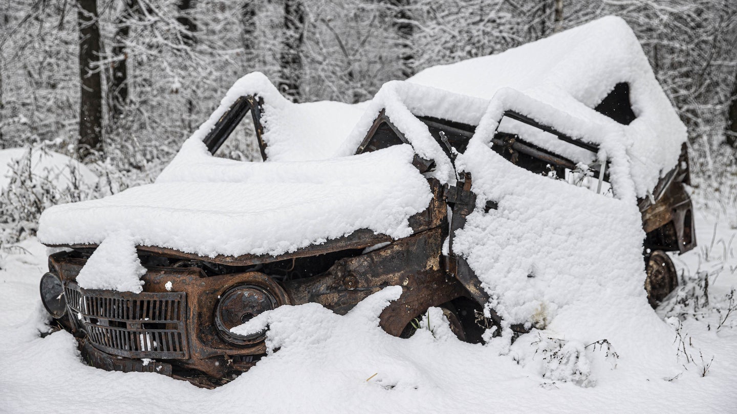 A view of an old car under the snow in Moschun Village, which has been destroyed as a result of intense bombardment by the Russian army trying to seize Hostomel Airport for days, now living conditions become more difficult with snowfall in Kyiv, Ukraine on November 19, 2022. (Photo by Metin Aktas/Anadolu Agency via Getty Images)