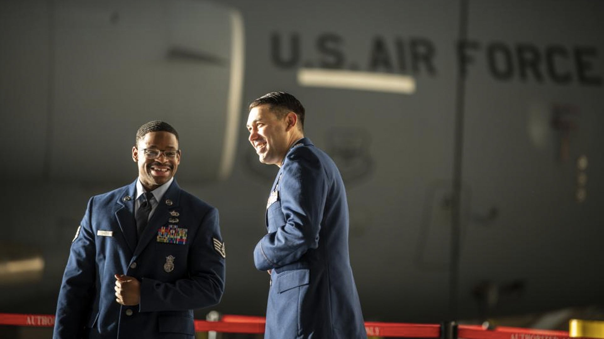 U.S. Air Force Staff Sgt. E-Quantay Mason, left, Phoenix Raven with REACH 651, and Maj. Drew Dela Cruz, C-17 pilot and REACH 651 aircraft commander, share a moment before receiving the Distinguished Flying Cross from Maj. Gen. Corey Martin, 18th Air Force commander, at Travis Air Force Base, California, Dec. 9, 2022. (Nicholas Pilch/U.S. Air Force) 