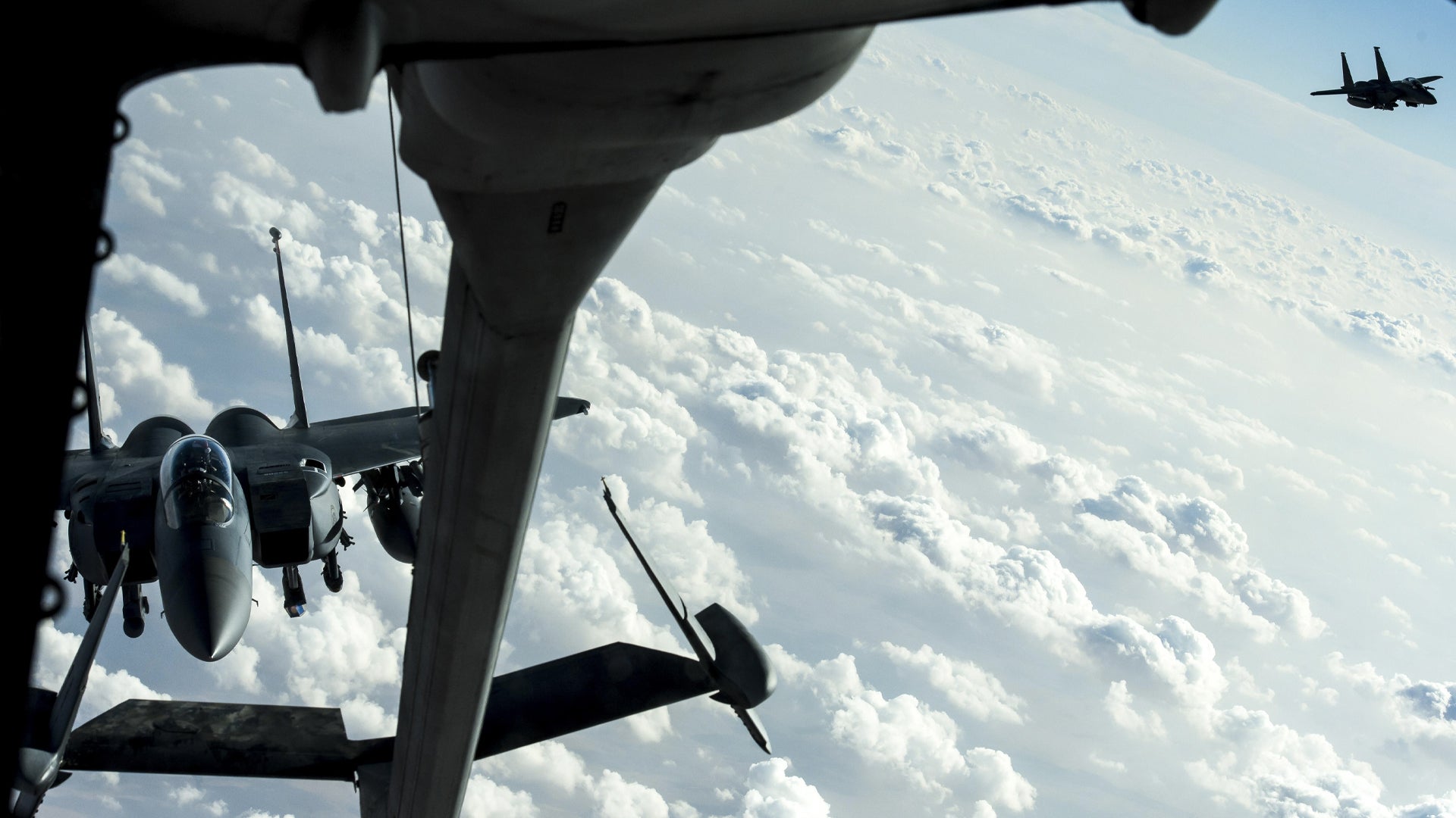 Two F-15E Strike Eagles prepare to receive fuel from a KC-10 Extender over Iraq, Dec. 25, 2016. The F-15s were providing precision guided close air support during Combined Joint Task Force-Operation Inherent Resolve, a multinational effort to weaken and destroy the Islamic State in Iraq and the Levant. (Senior Airman Tyler Woodward/U.S. Air Force)