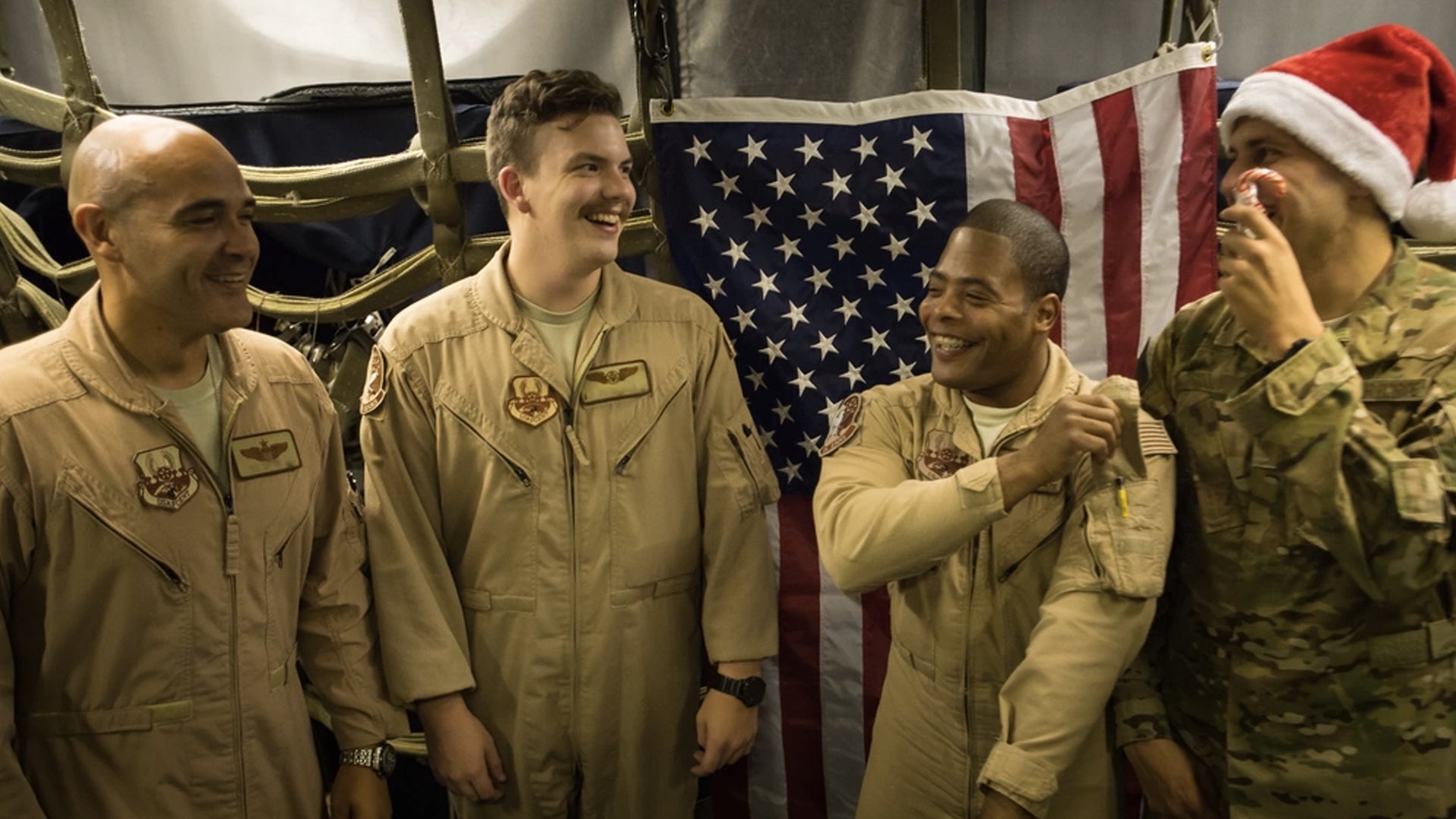 A 380th Air Expeditionary Wing KC-10 Extender aircrew laughs before a group photo after flying a sortie in support of Combined Joint Task Force-Operation Inherent Resolve at an undisclosed location in Southwest Asia, Dec. 25, 2016. (Senior Airman Tyler Woodward/U.S. Air Force)