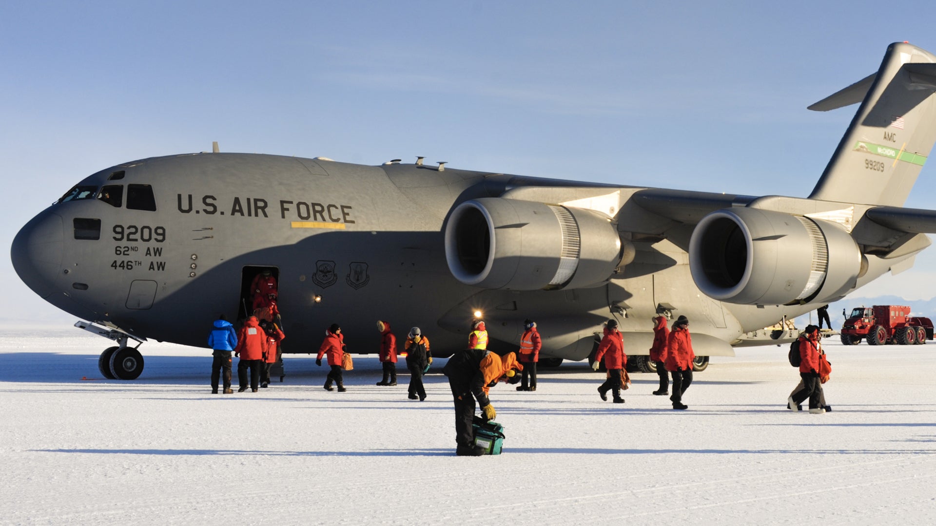 National Science Foundation personnel exit a C-17 Globemaster III aircraft, Oct. 1, 2012, at McMurdo Station, Antarctica. Every year, Airmen from the 62nd and 446th Airlift Wings at Joint Base Lewis-McChord deploy to transport cargo and personnel in support of the NSF and Operation Deep Freeze. (Staff Sgt. Sean Tobin/U.S. Air Force)