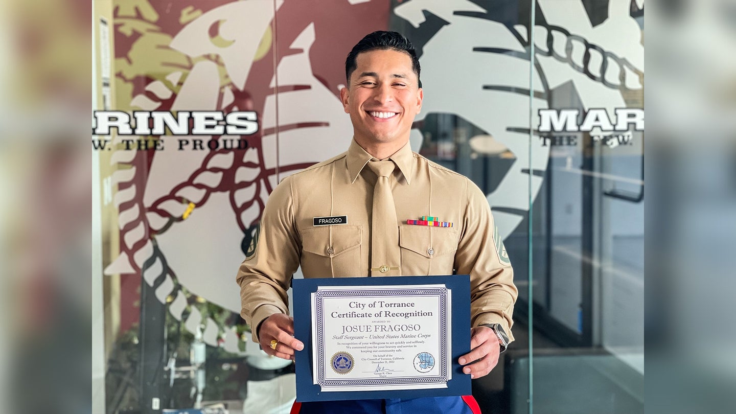 U.S. Marine Corps Staff Sergeant Josue Fragoso, the station commander of Recruiting Sub Station South Bay, Recruiting Station Orange County, 12th Marine Corps District, poses for a photo with a certificate of recognition from Torrance Mayor, George Chen, in Torrance, California on Dec. 22, 2022. (U.S. Marine Corps photo by Staff Sgt. Immanuel Johnson)