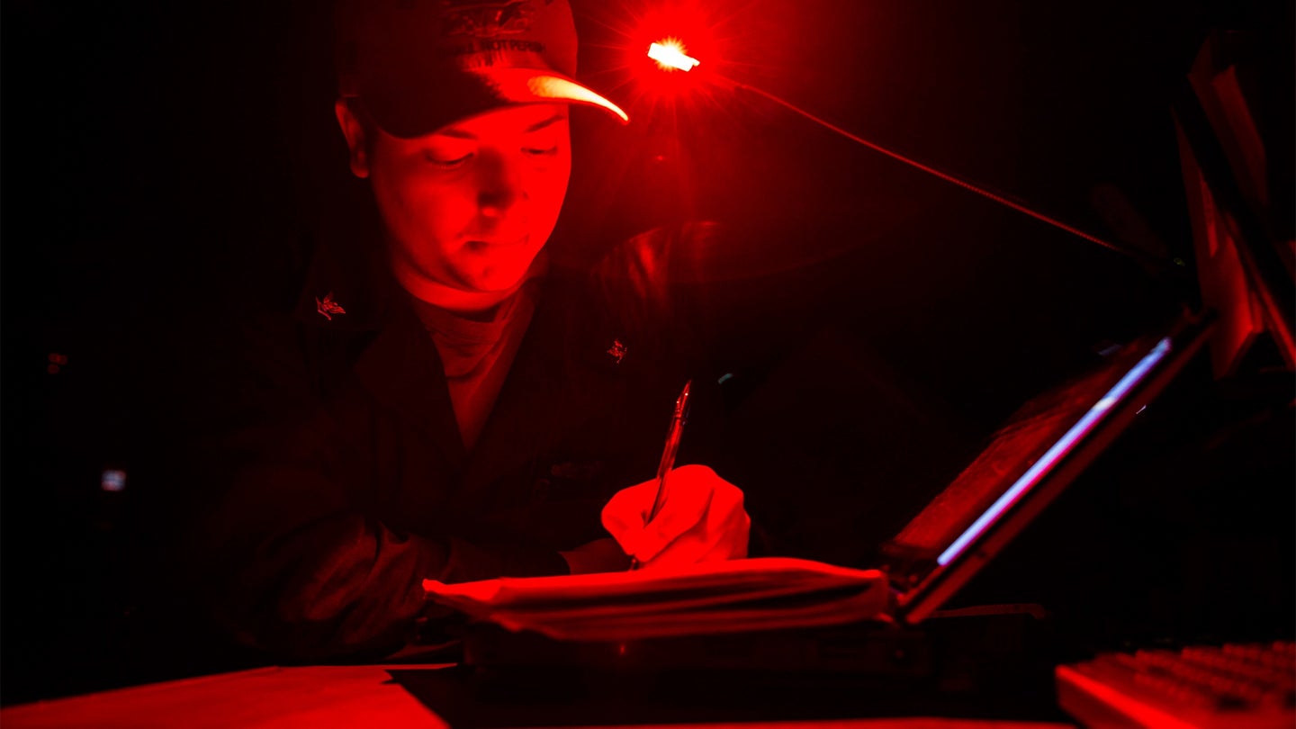 Quartermaster 3rd Class Ryan Gouger, from Newberg, Ore., writes the first deck log of the year while standing Quartermaster of the Watch on the bridge of the aircraft carrier USS Abraham Lincoln (CVN 72) on Jan. 1, 2020. (U.S. Navy photo by Mass Communication Specialist 3rd Class Dan Snow)