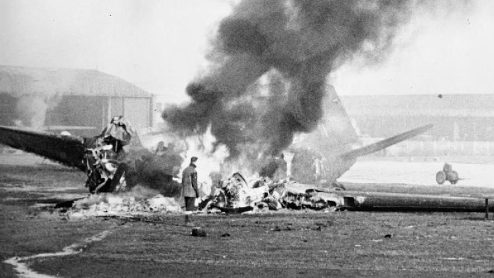 A Douglas Dakota of RAF Transport Command, destroyed during the attack on B58/Melsbroek, Belgium, by Luftwaffe fighter-bombers during Operation Bodenplatte in World War II, burns itself out. (Royal Air Force)