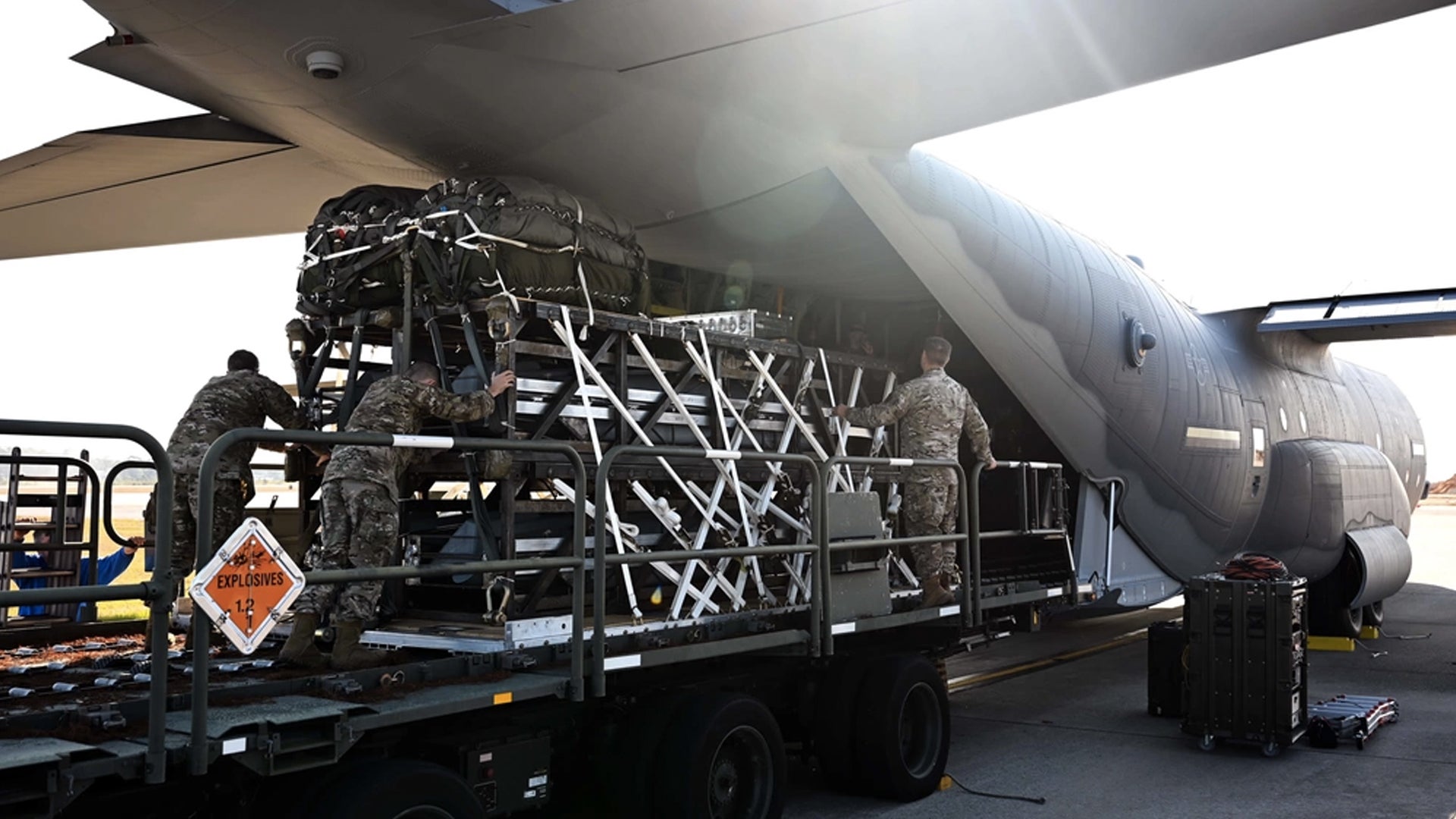 Airmen and riggers with the 1st Special Operations Squadron Logistics Readiness Squadron load a Rapid Dragon Palletized Weapon System aboard an MC-130J Commando II at Hurlburt Field, Florida, Dec. 13, 2021. (Staff Sgt. Brandon Esau/U.S. Air Force)