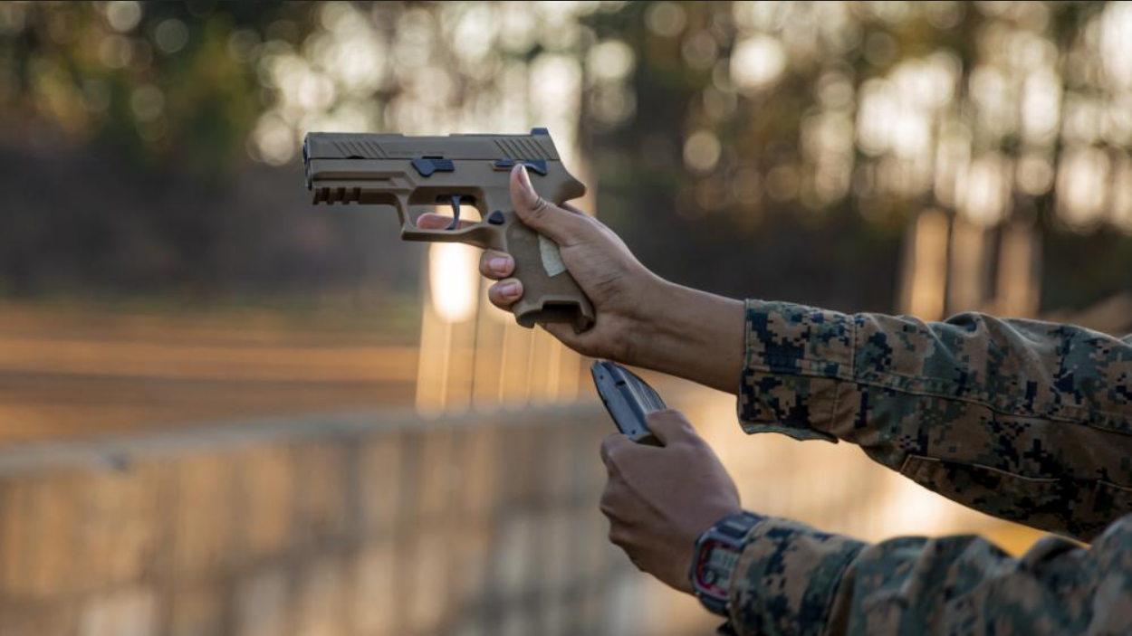 A Marine reloads a M18 pistol at Marine Corps Base Camp Lejeune, North Carolina. (Photo by Lance Cpl. Joel Castaneda-Rodriguez)