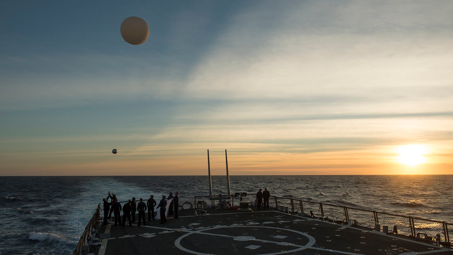 Sailors aboard the Arleigh Burke class guided-missile destroyer USS Donald Cook (DDG 75) launch a weather balloon carrying a metal sphere to calibrate the ship's radar. (U.S. Navy photo by Mass Communication Specialist Adam Austin/Released)