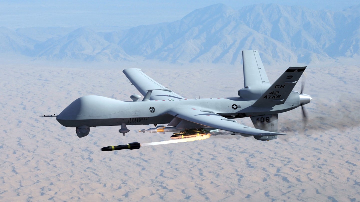 A U.S. Air Force MQ-9 Reaper drone firing a AGM-114 Hellfire missile.