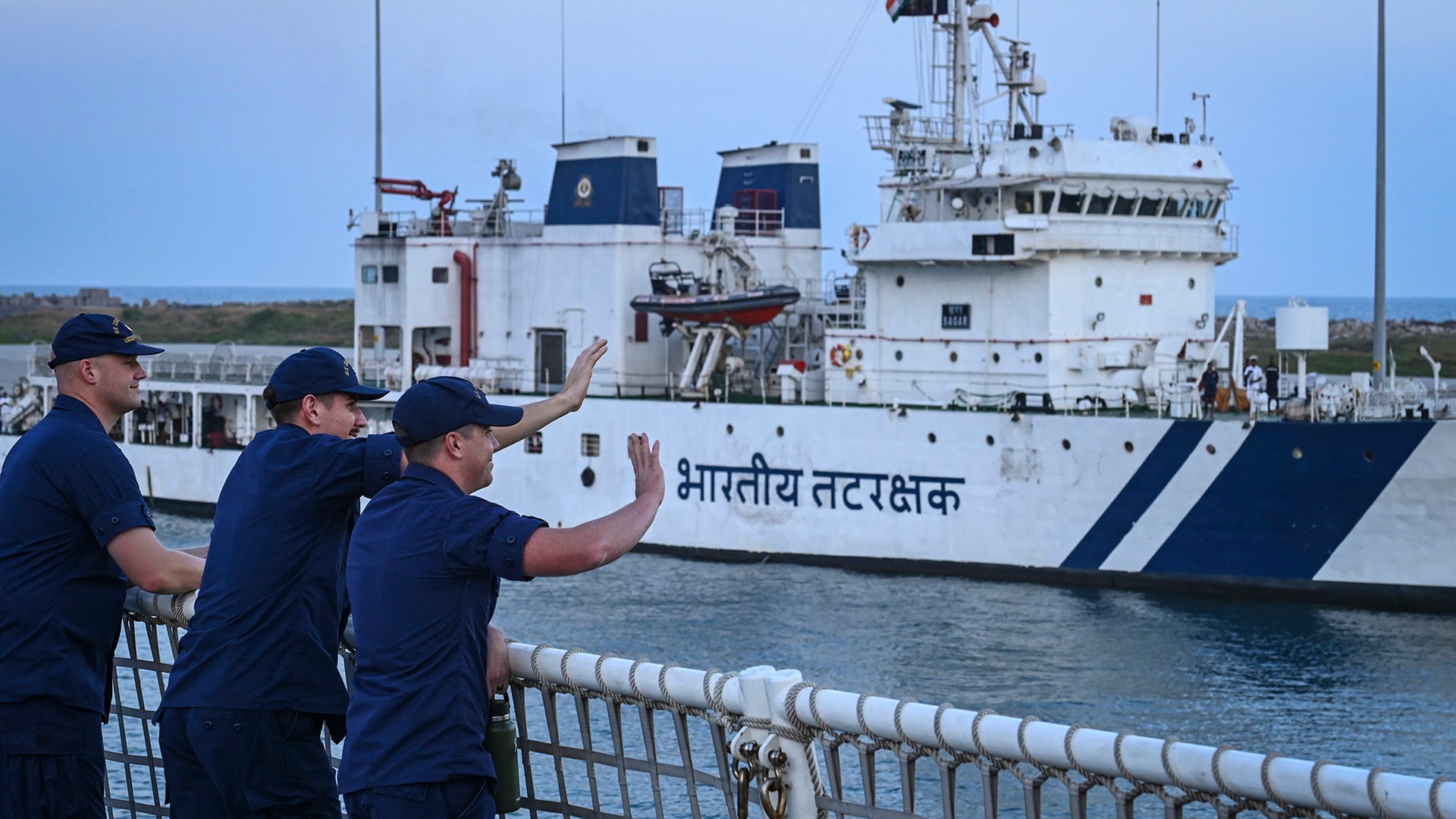 Members from U.S. Coast Guard Cutter Midgett (WMSL 757) wave to individuals aboard an Indian Coast Guard vessel as the cutter pulled into Chennai, India, on Sept. 16, 2022. The crew of the Midgett is on a several-month deployment to promote a free and open Indo-Pacific. (U.S. Coast Guard photo by Petty Officer Steve Strohmaier)