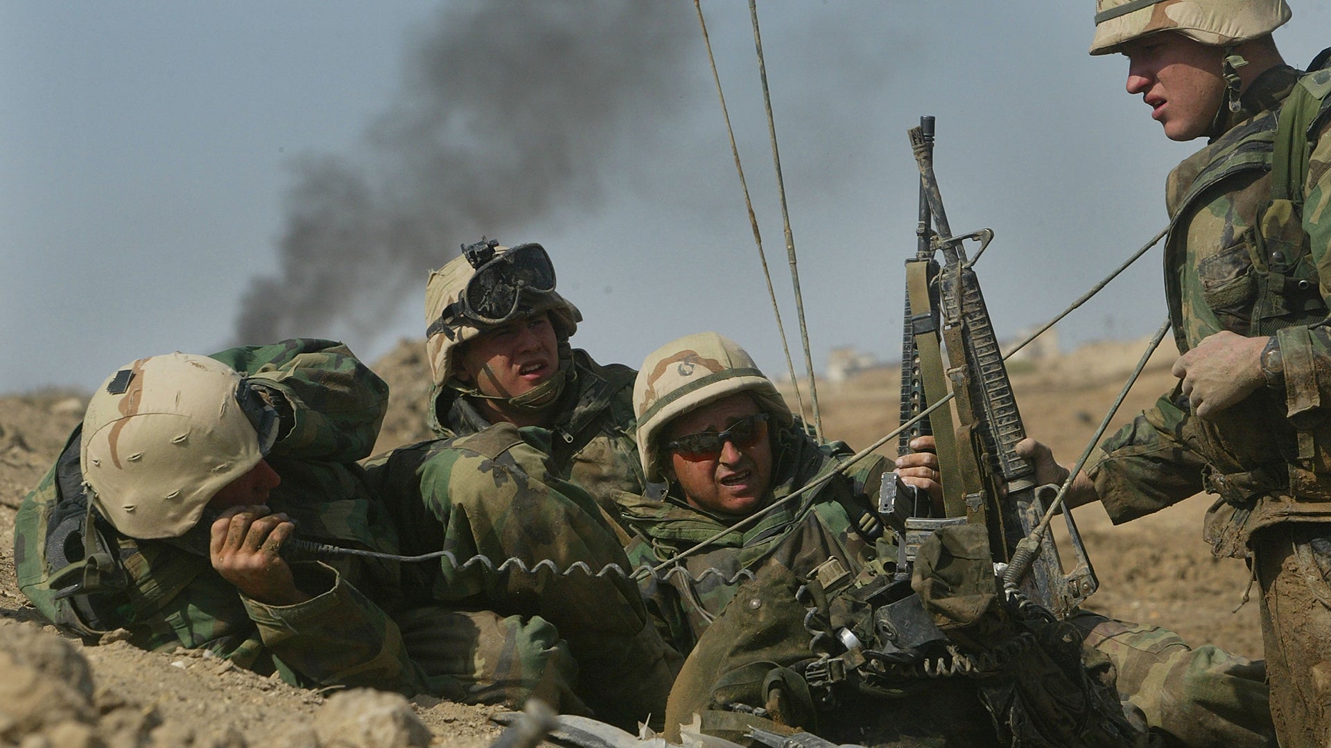NASIRIYAH, IRAQ - MARCH 23: U.S. Marines from 1 / 2 Charlie Co. of Task Force Tarawa keep low, as they battle with Iraqi forces March 23, 2003 in the southern Iraqi city of Nasiriyah. The Marines suffered a number of deaths and casualties during gun battles throughout the city. (Photo by Joe Raedle/Getty Images)