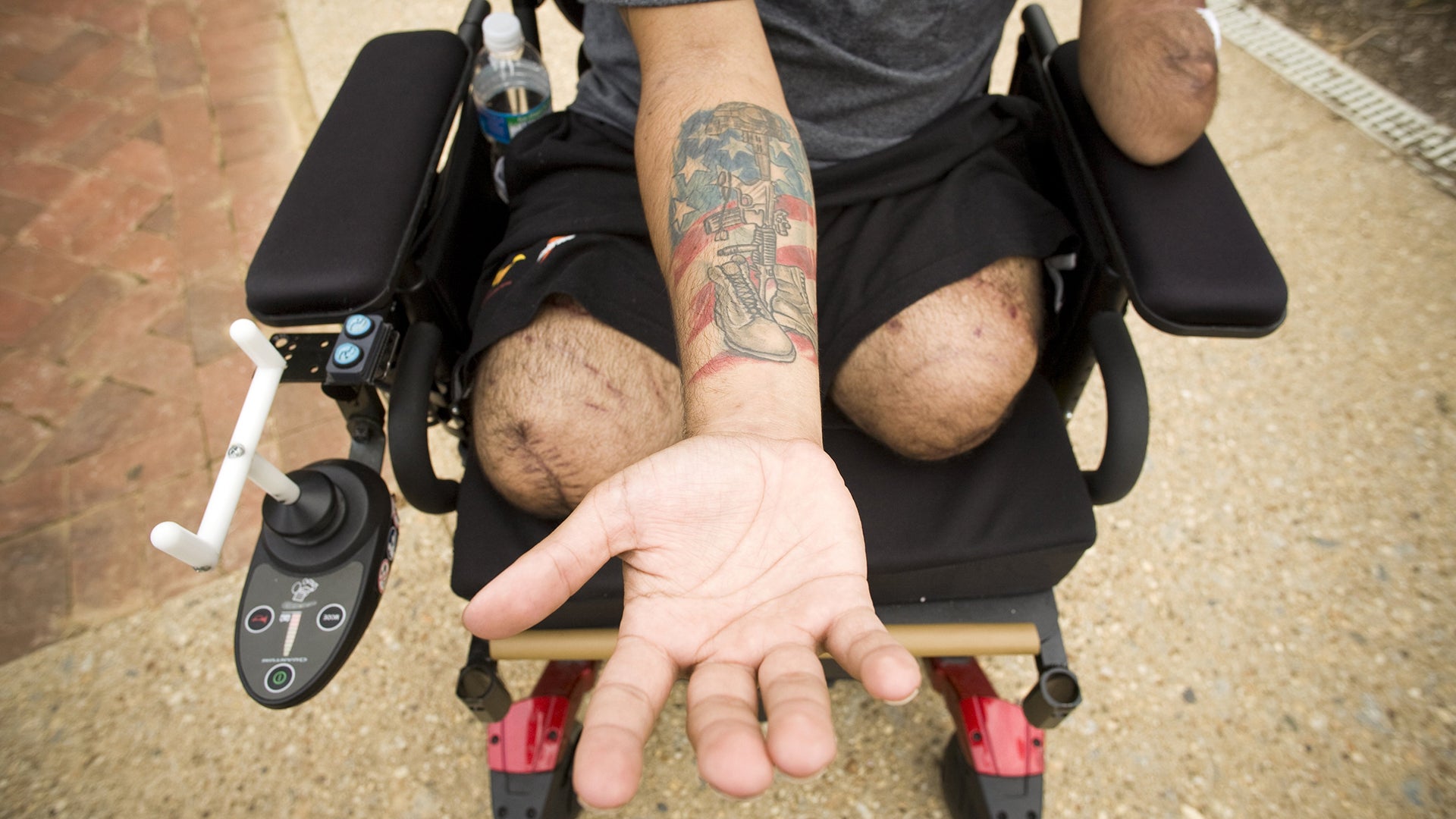 WASHINGTON, DC - JULY 30: Iraq war veteran SGT Luis Rosa-Valentin, who lost both of his legs, left arm and hearing while serving in Iraq shows the tattoo he got in memory of a friend killed in Iraq, at Walter Reed Army Medical Center in Washington, DC on July 30, 2008. His encounter with the improvised explosive device that almost ended his life came in April, during his second tour in the combat zone. Rosa-Valentin is still recovering at Walter Reed. He speaks of his time in the Army with no regrets. " I was born for it, really, I loved every second of it, he said. Despite my injuries, I still don't care, I love it. I love the infantry, I love the life that I led. I wouldn't trade a second of it for anything else".  (Photo by David S. Holloway/Getty Images)