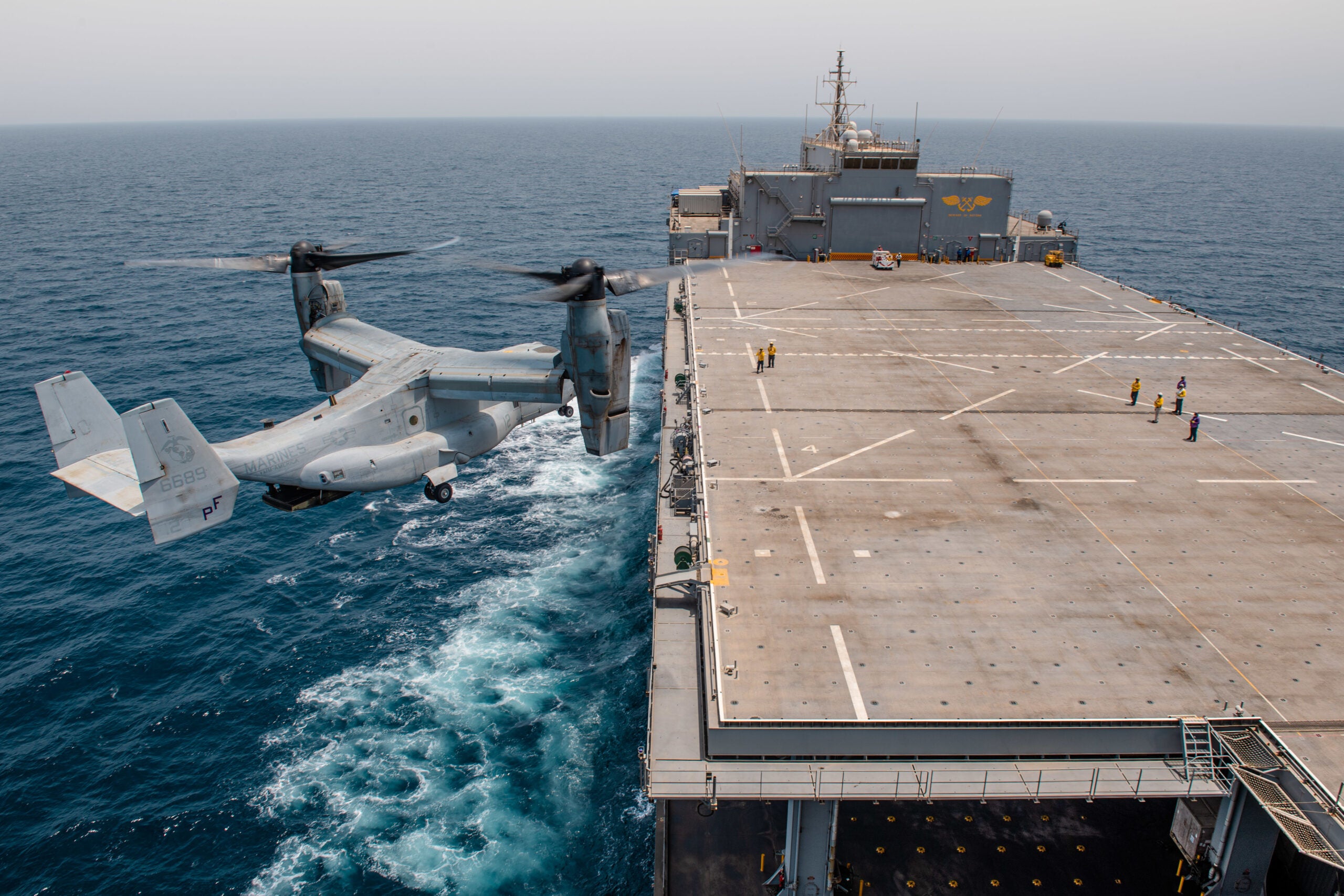 210716-N-KZ419-1575 ARABIAN GULF (July 16, 2021) – An MV22 Osprey helicopter attached to Task Force 51/5 prepares to land aboard expeditionary sea base USS Lewis B. Puller (ESB 3), during flight operations in the Arabian Gulf, July 16. Lewis B. Puller is deployed to the U.S. 5th Fleet area of operations in support of naval operations to ensure maritime stability and security in the Central Region, connecting the Mediterranean and Pacific through the Western Indian Ocean and three strategic choke points. (U.S. Navy photo by Mass Communication Specialist 2nd Class Dawson Roth)
