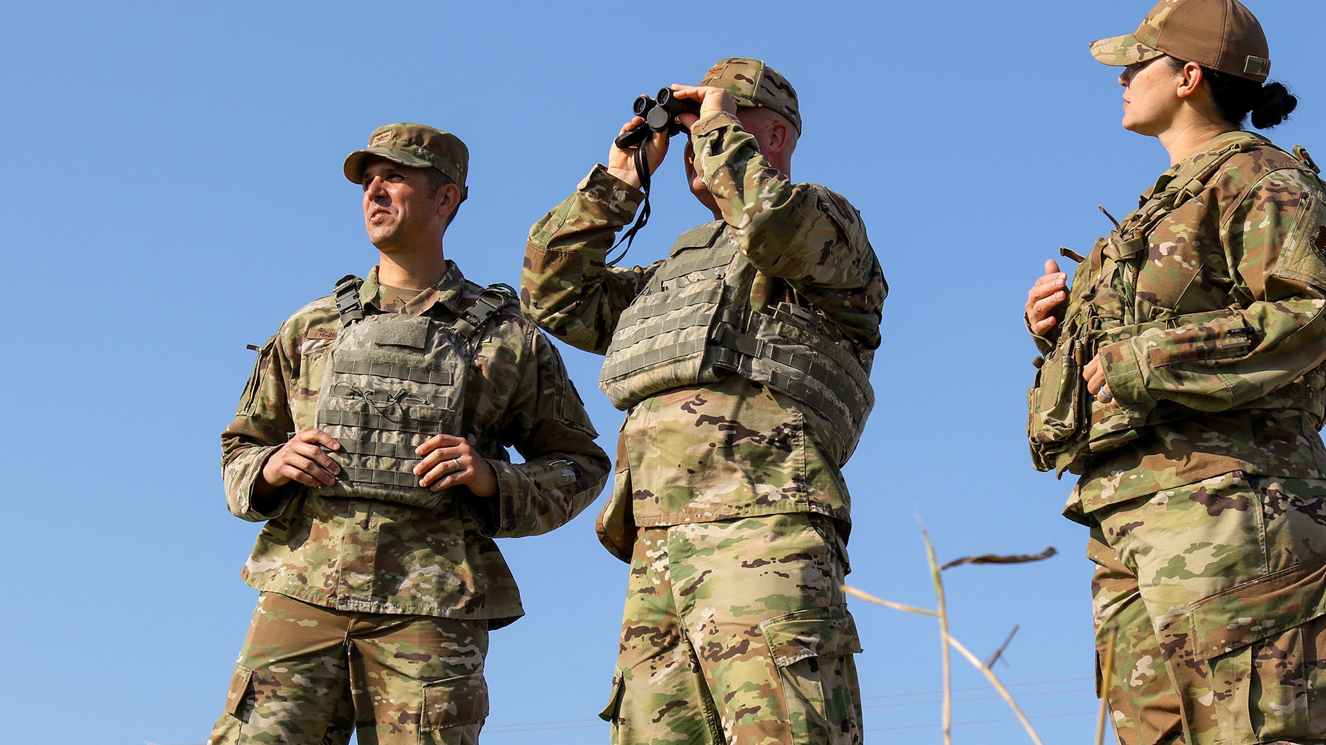 Col Andrew Camacho (left), 147th Attack Wing Commander, and Chief Master Sgt. (right), 147th Attack Wing Command Chief, look across the Texas-Mexico border in the Rio Grande Valley area of south Texas, February 22, 2022. The Wing leaders visited with members of the 147th Attack Wing deployed to the border for Operation Lone Star.