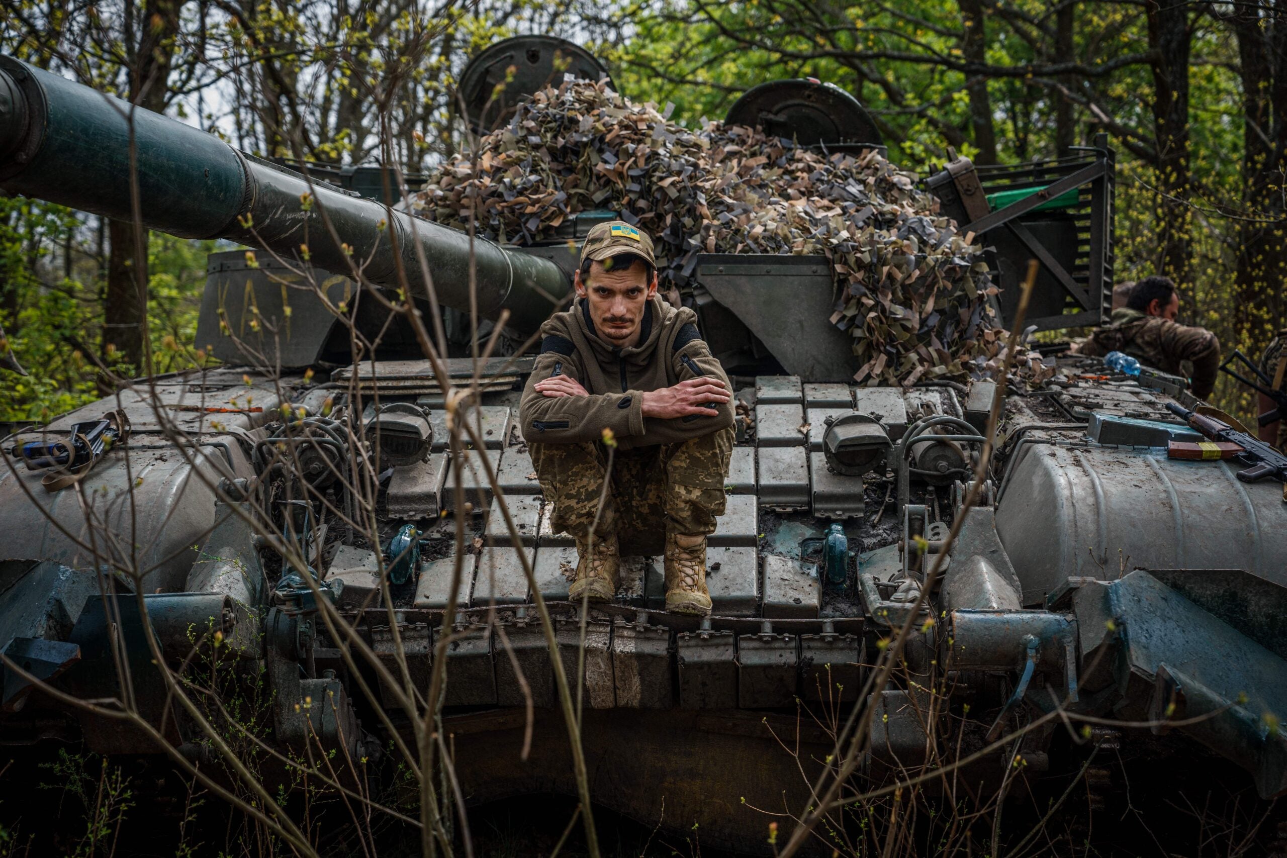 TOPSHOT - A Ukrainian serviceman sits on his tank at position near the frontline city of Bakhmut, Donetsk region on April 29, 2023, amid the Russian invasion of Ukraine. (Photo by Dimitar DILKOFF / AFP) (Photo by DIMITAR DILKOFF/AFP via Getty Images)
