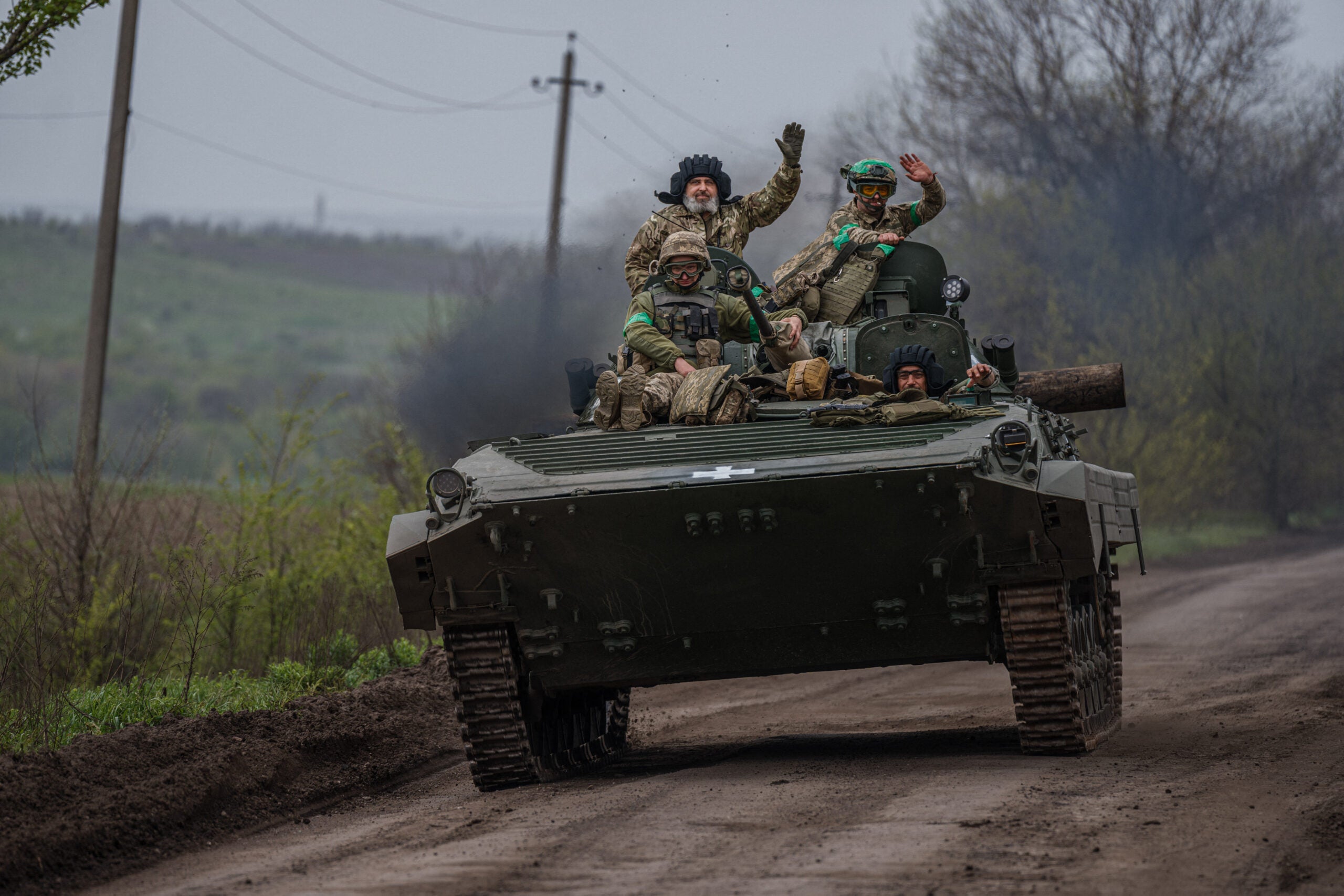 Ukrainian servicemen ride in a BMP infantry fighting vehicle near the town of Bakhmut, in the Donetsk region, on April 28, 2023, amid the Russian invasion on Ukraine. (Photo by Dimitar DILKOFF / AFP) (Photo by DIMITAR DILKOFF/AFP via Getty Images)