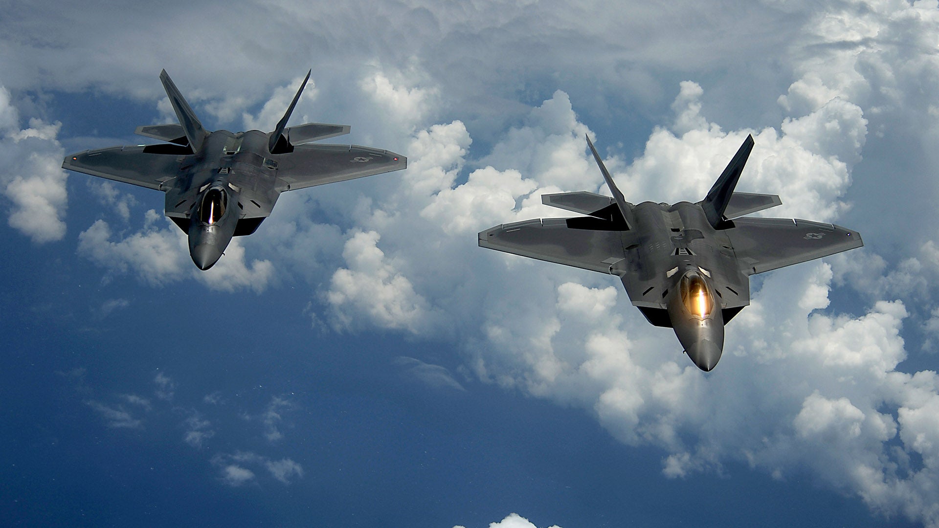 A pair of 1st Fighter Wing's F-22 Raptors from Joint Base Langley-Eustis, Va., pulls away and flies behind a KC-135 Stratotanker with the 756th Air Refueling Squadron, Joint Base Andrews Naval Air Facility, Md. after receiving fuel off the east coast on July 10, 2012. The first Raptor assigned to the Wing arrived Jan. 7, 2005. This aircraft was allocated as a trainer, and was docked in a hanger for maintenance personnel to familiarize themselves with its complex systems. The second Raptor, designated for flying operations, arrived Jan. 18, 2005. On Dec. 15, 2005, Air Combat Command commander, along with the 1st FW commander, announced the 27th Fighter Squadron as fully operational capable to fly, fight and win with the F-22.