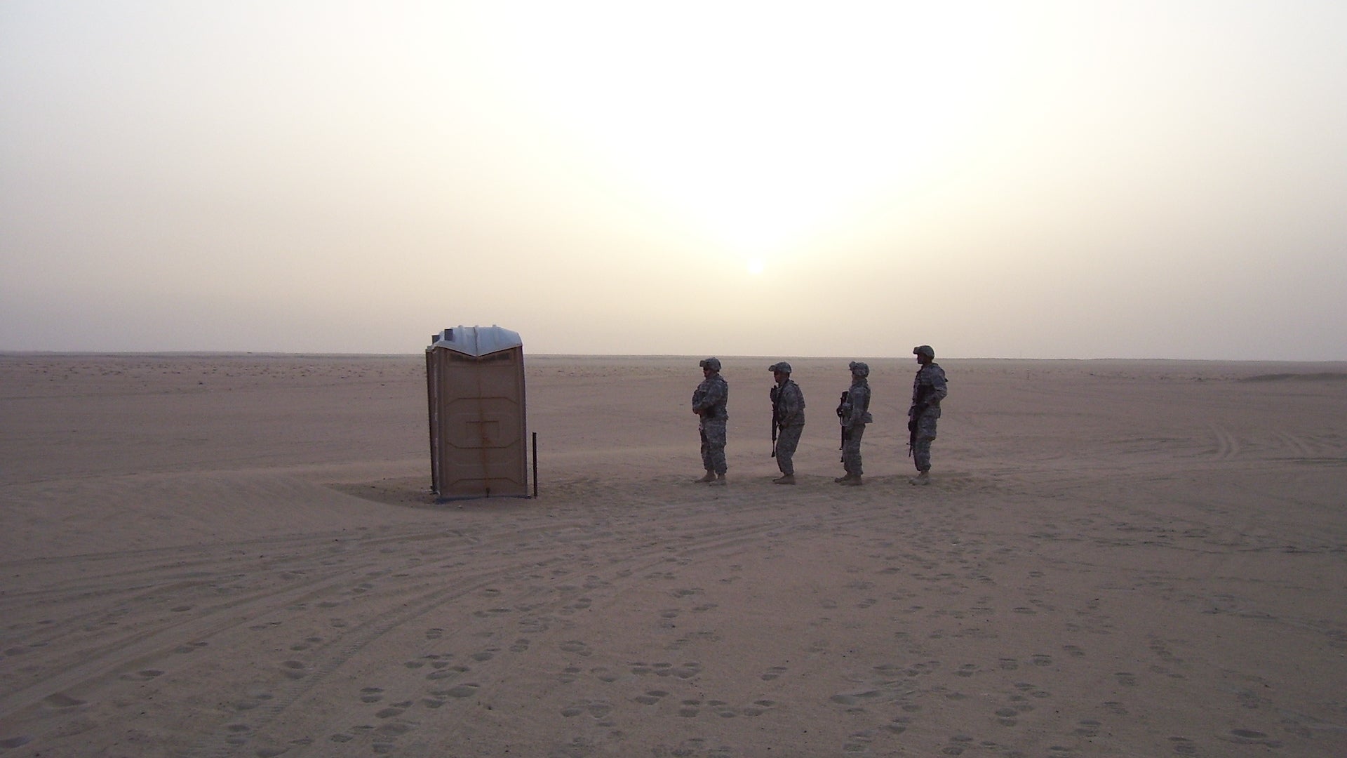 Sailors assigned to Navy Provisional Detainee Battalion VI wait to use the portable toilet while training at the Udari Range in Kuwait. (U.S. Navy photo by Chief Master-at-Arms Tony Guyette/Released).