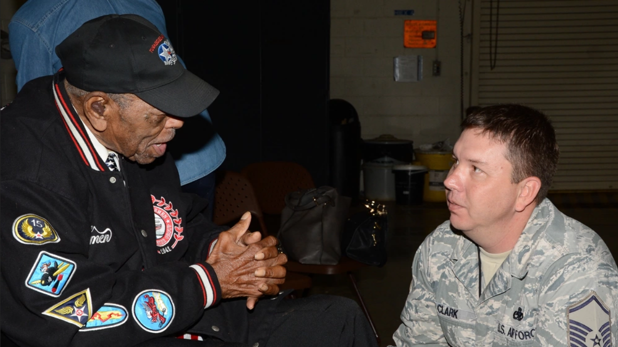 Homer Hogues, one of the Tuskegee Airmen, talks with Master Sgt. Wesley Clark, 2nd Aircraft Maintenance Squadron, at Barksdale Air Force Base in 2014. (Photo courtesy U.S. Air Force)