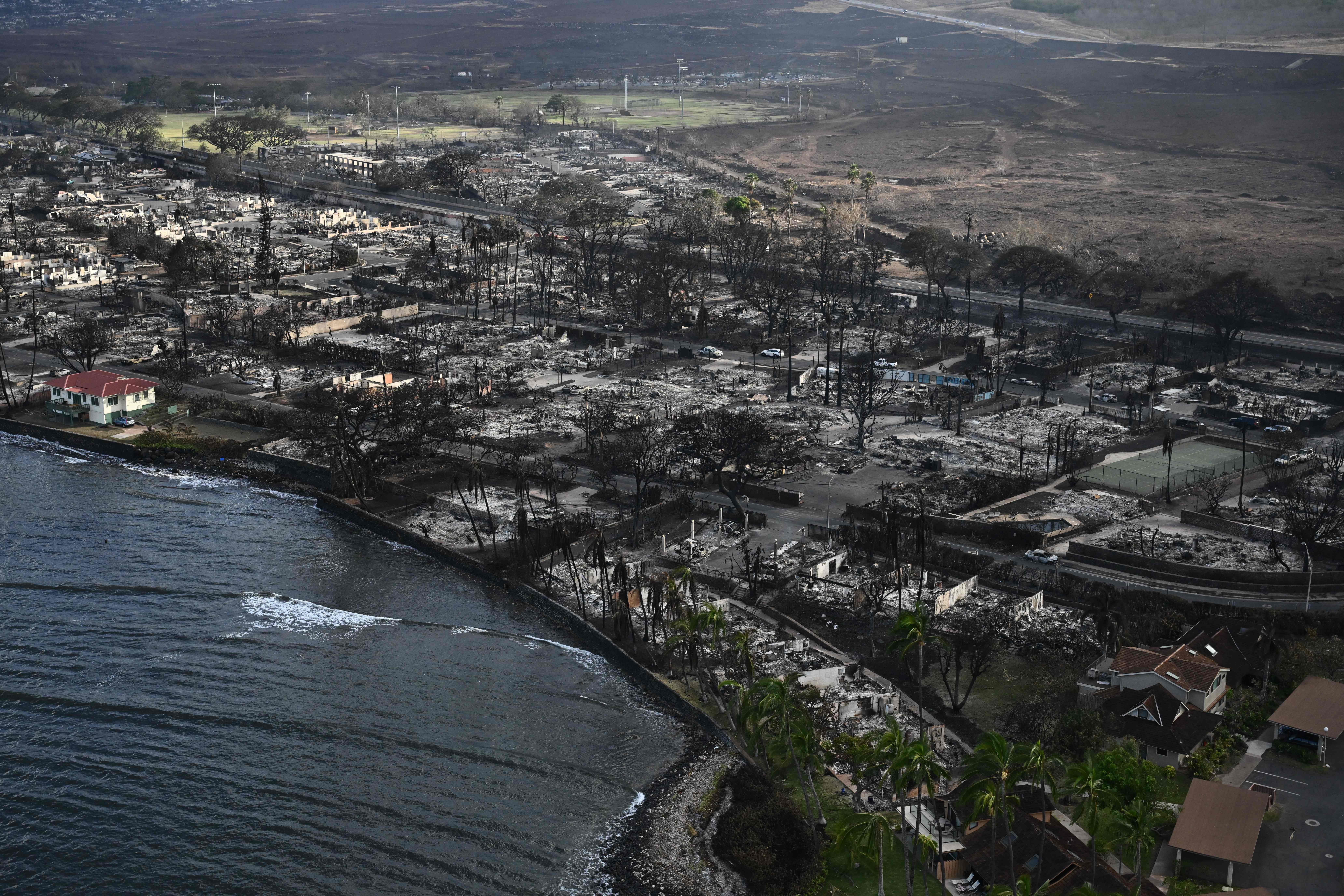 An aerial view of Lahaina after wildfires burned through the town on the Hawaiian island of Maui, on August 10, 2023. At least 36 people have died after a fast-moving wildfire turned Lahaina to ashes, officials said August 9, as visitors asked to leave the island of Maui found themselves stranded at the airport. The fires began burning early August 8, scorching thousands of acres and putting homes, businesses and 35,000 lives at risk on Maui, the Hawaii Emergency Management Agency said in a statement. (Photo by Patrick T. Fallon / AFP) (Photo by PATRICK T. FALLON/AFP via Getty Images)