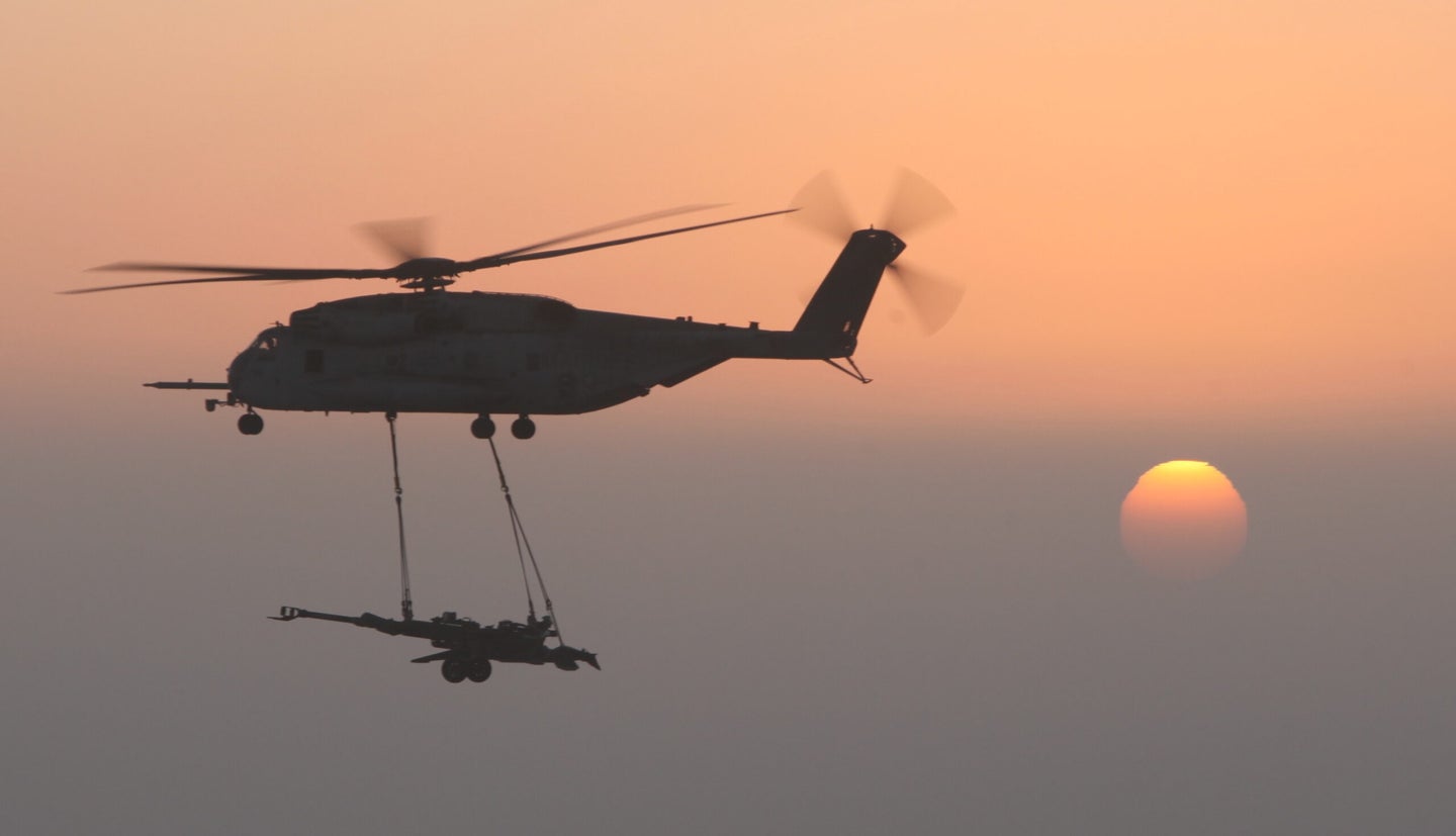 A Marine helicopter carries M777 artillery