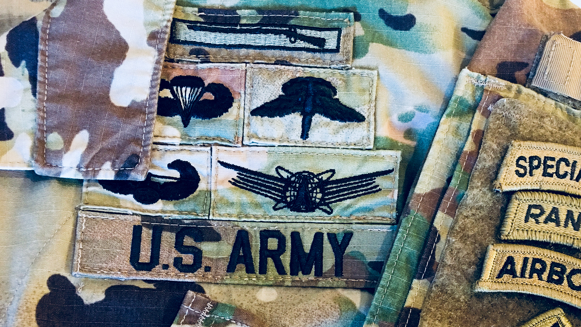 A stack of skill badges on a Army soldier's uniform.