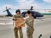Spc. Wilson Rodriguez, 452d Combat Support Hospital laboratory technologist, receives critical blood products from a U.S. Army UH-60 Black Hawk helicopter assigned to Company C, 2d Battalion, 211th Aviation Regiment at Camp Arifjan Kuwait, March 13, 2019. (U.S. Army Reserve photo by Sgt. Philip Ribas)