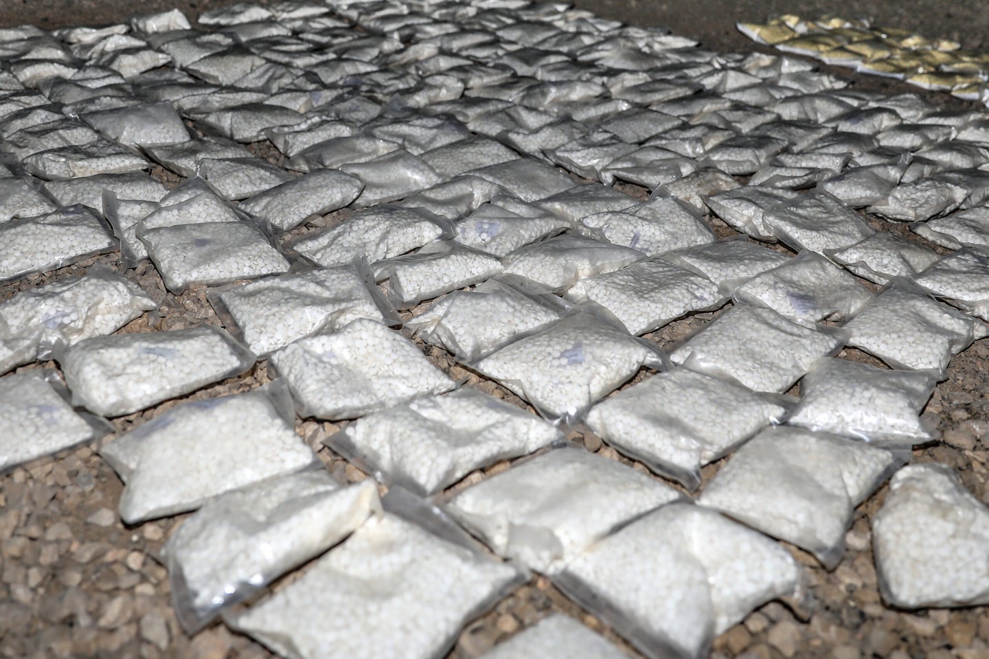 Over 127 plastic bags filled with an addictive drug called Captagon lie ready for destruction after being seized by U.S. and Coalition partners in Southern Syria, May 31, 2018. Reports have surfaced that captagon was taken widely by Hamas fighters to fuel the October 7 murder spree in Israel. Army photo by Staff Sgt. Christopher Brown.