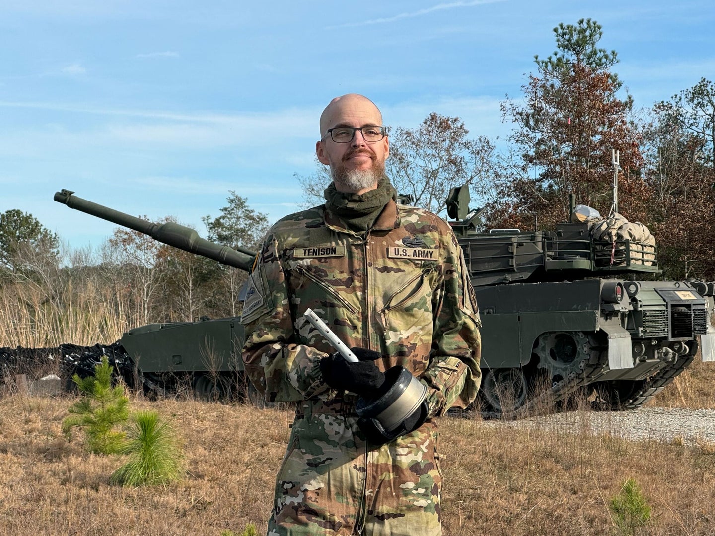 Jay Tenison in front of tank