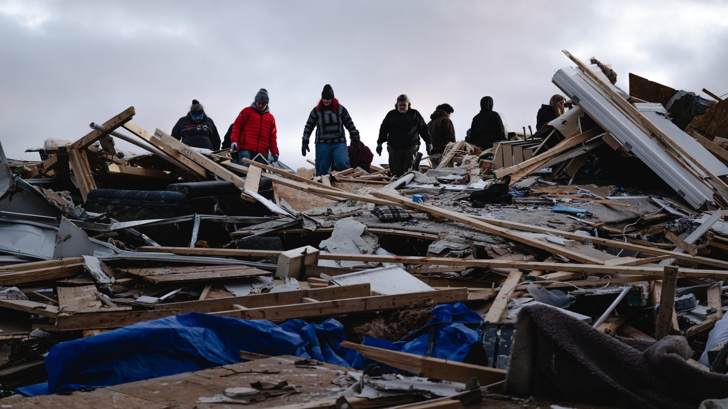 CLARKSVILLE, TENNESSEE - DECEMBER 10: Residents and visitors work to clear debris in search of pets and belongings of a destroyed home in the aftermath of a tornado on December 10, 2023 in Clarksville, Tennessee. Multiple long-track tornadoes were reported in northwest Tennessee on December 9th causing multiple deaths and injuries and widespread damage. (Photo by Jon Cherry/Getty Images)