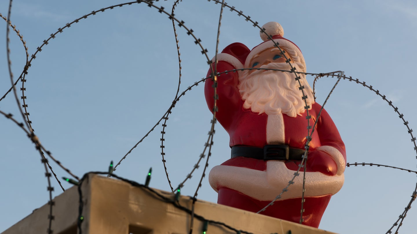 Santa decoration surrounded by concertina wire.