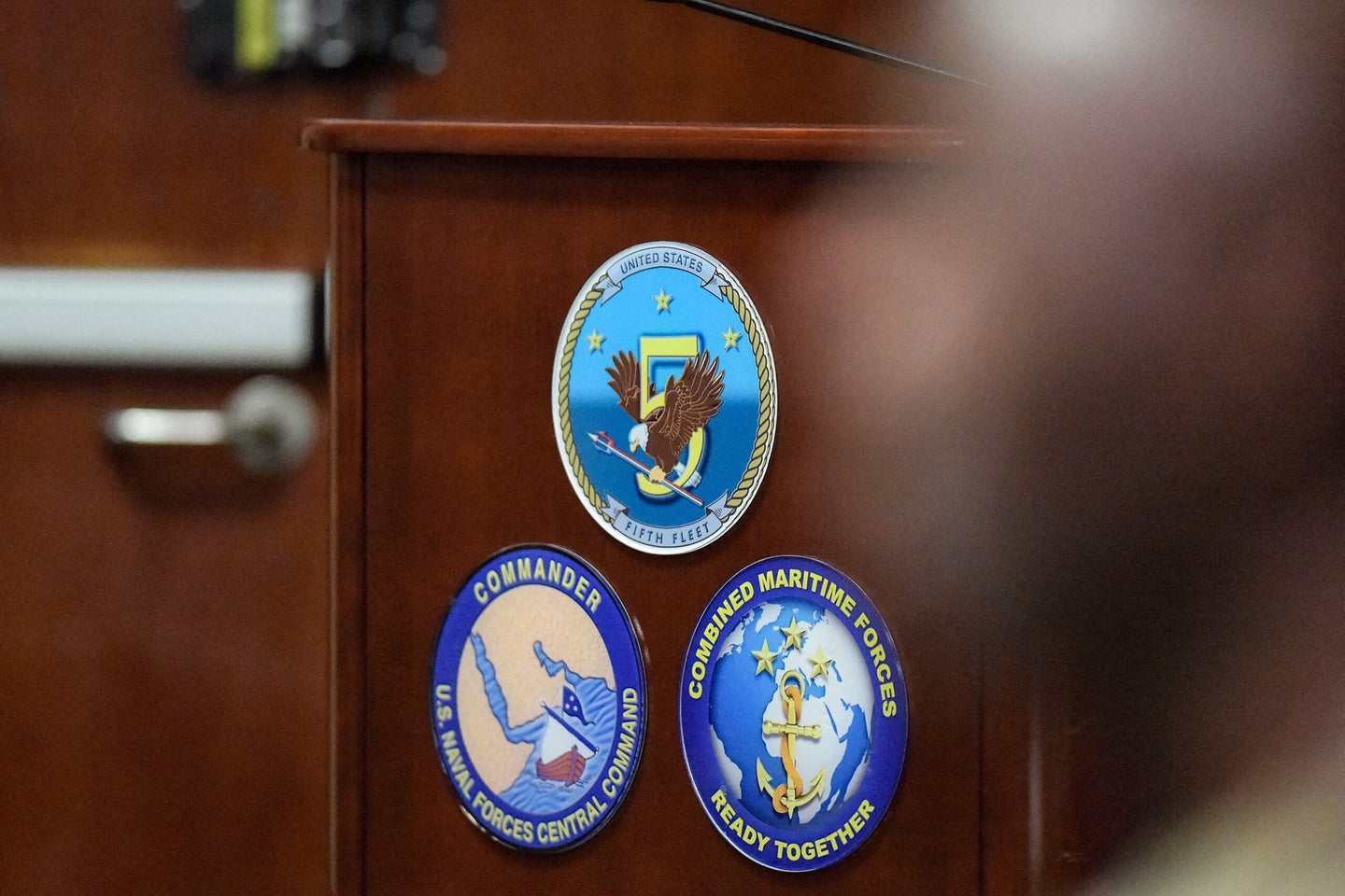 A picture shows the logos of the US Navy 5th Fleet Command at their headquarters in Bahrain's capital Manama on August 13, 2023. As Iranian seizures threaten oil tankers plying the Gulf, the United States is raising its military presence, a move long demanded by Arab Gulf states who accused Washington of retreating from the region. (Photo by Mazen Mahdi / AFP) (Photo by MAZEN MAHDI/AFP via Getty Images)