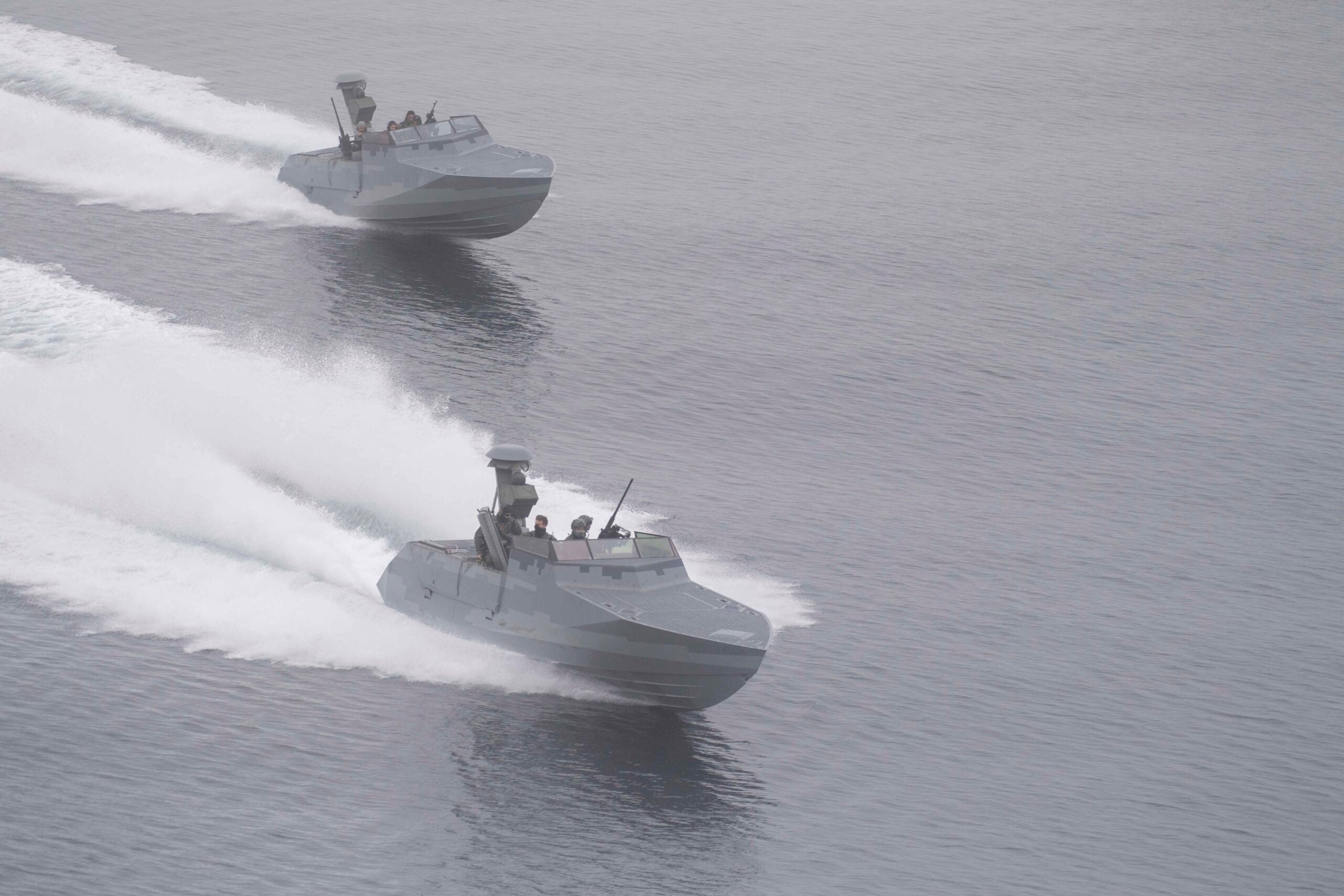 Two Combatant Craft Assault boats conduct high speed tests after launching from well deck of amphibious transport dock ship USS John P. Murtha (LPD 26) during Operation POLAR DAGGER, Aug. 23, 2023. Amphibious transport dock ships like John P. Murtha have many unique capabilities that make them ideal platforms to support special operations forces, such as the ability to embark helicopters from the joint force, launch and recover Naval Special Warfare combatant craft, and maintain all-domain awareness through advanced sensors. Operations NOBLE DEFENDER and POLAR DAGGER sharpen joint special operations integration and provides the forces the opportunity to test new capabilities and advance response options in defense of the U.S. homeland. (U.S. Navy photo by Mass Communication Specialist 2nd Class Joshua Samoluk)