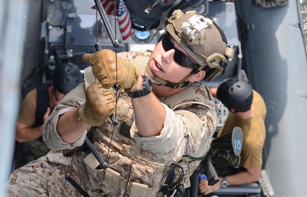 A Navy SEAL climbs a caving ladder during visit, board, search and seizure (VBSS) training on Joint Expeditionary Base Little Creek-Fort Story in 2013.Photograph by Mass Communication Specialist 2nd Class William S. Parker.