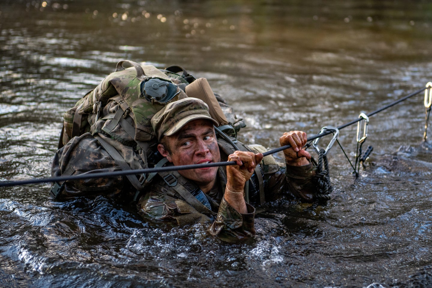 A Ranger candidate crossing a river during Florida Phase of Ranger School.
