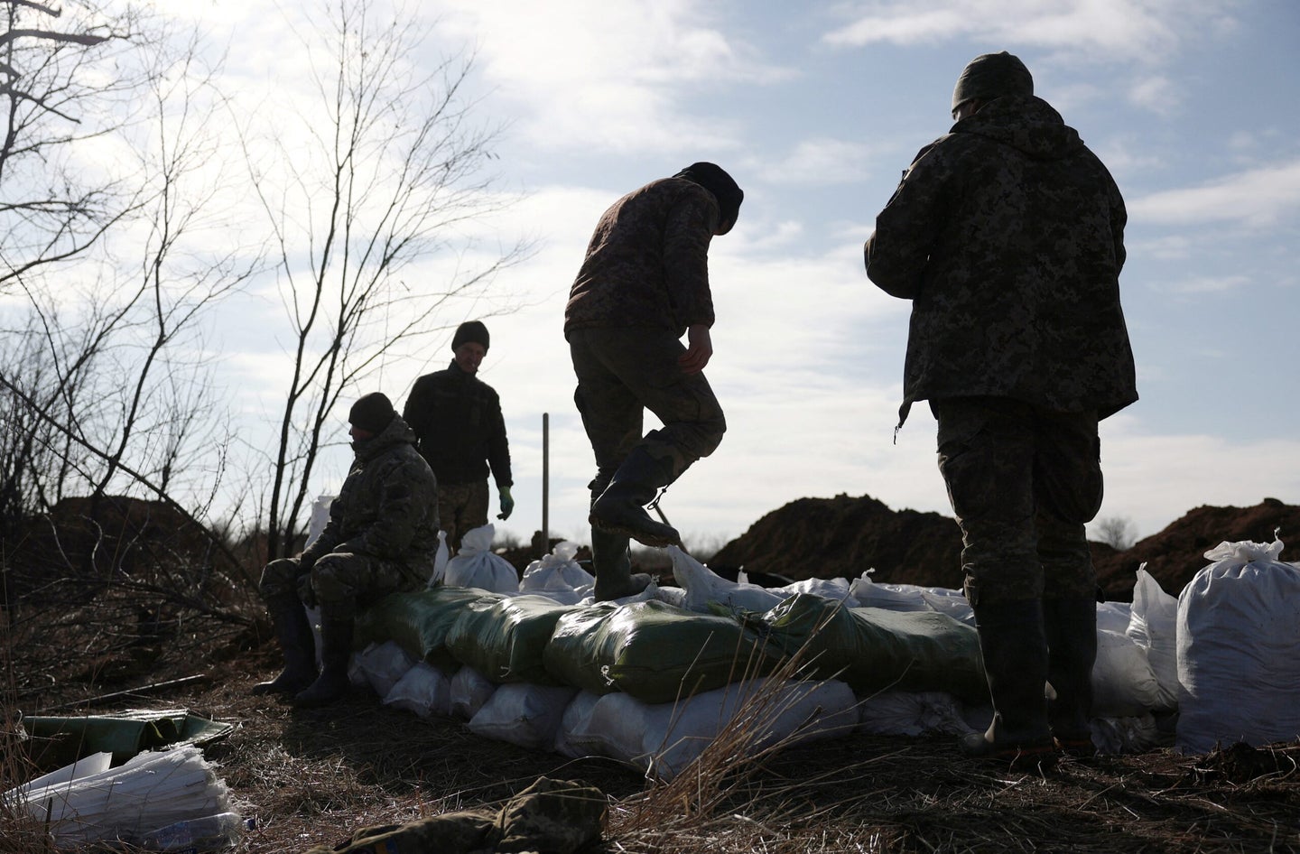 Ukrainian servicemen pile up earthbags to build a fortification not far from town of Avdiivka in the Donetsk region, amid the Russian invasion of Ukraine, on February 17, 2024. (Photo by Anatolii STEPANOV / AFP) (Photo by ANATOLII STEPANOV/AFP via Getty Images)